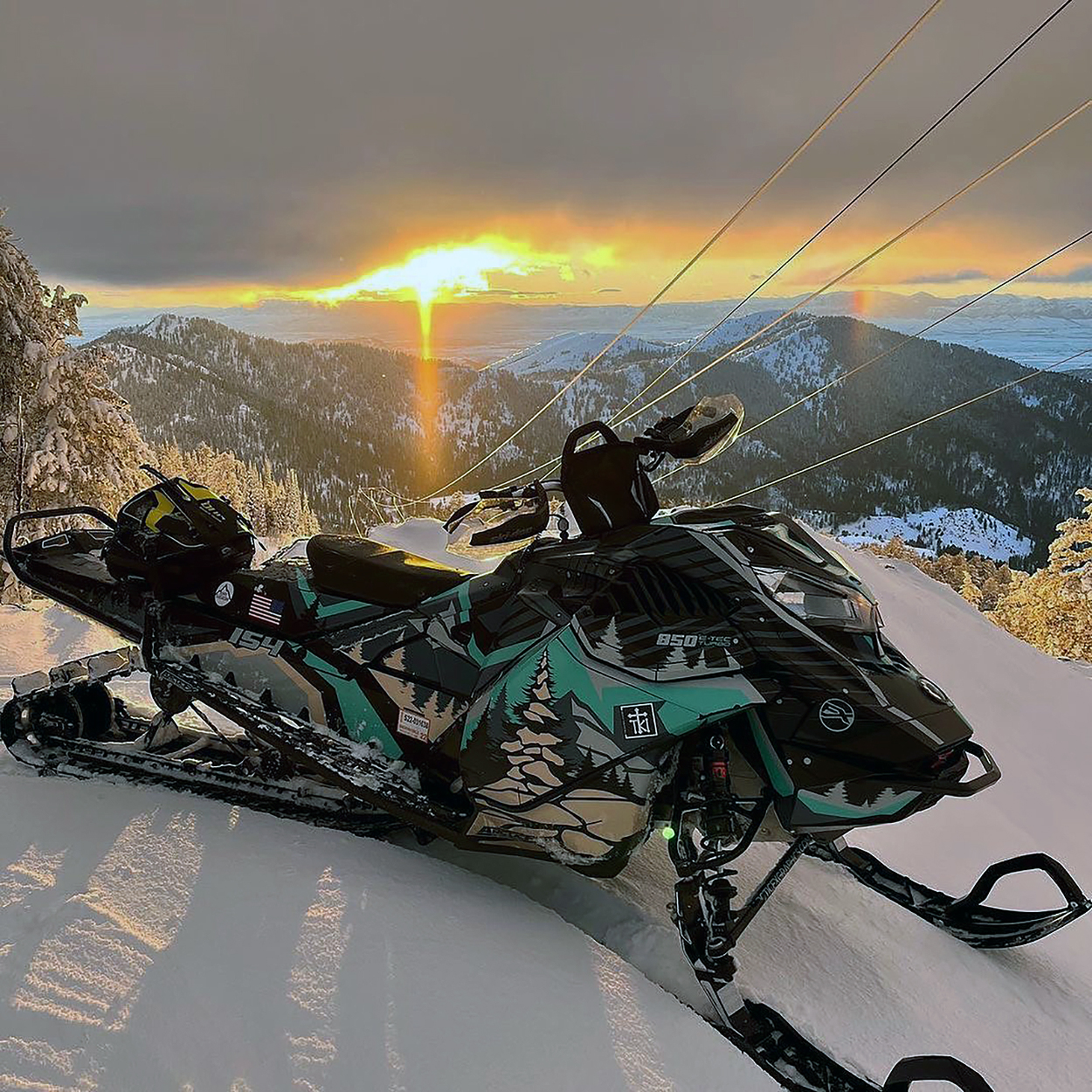 A Ski-Doo Gen4 Lightweight snowmobile with a gray, aqua, and black Leif Alvarsson Kingdom custom vinyl wrap.