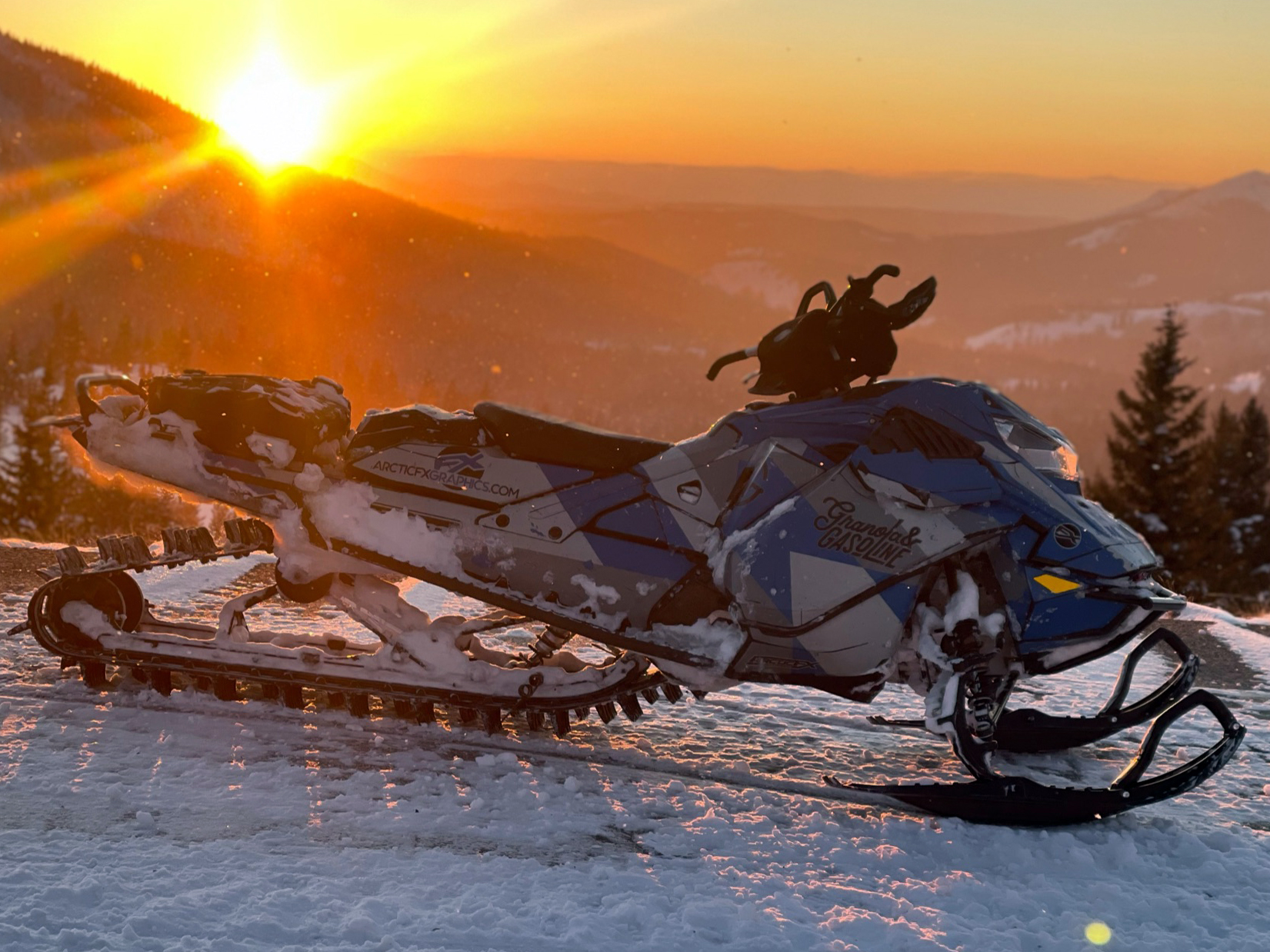 A Ski-Doo Gen4 Lightweight snowmobile with a blue, gray, and black Diversion custom vinyl wrap.