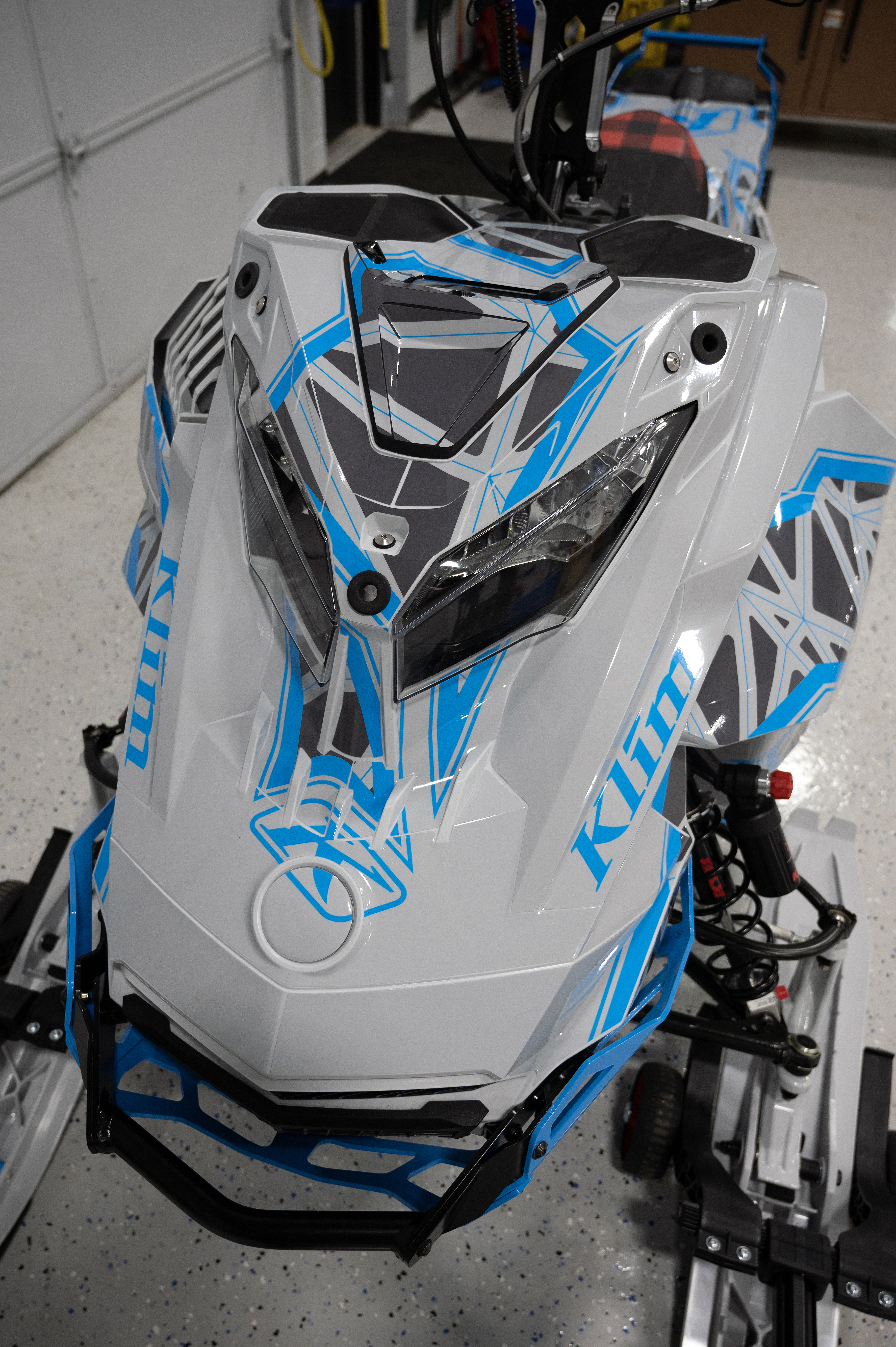 A Ski-Doo Gen4 Lightweight snowmobile with a gray and blue Klim Demolish custom vinyl wrap.