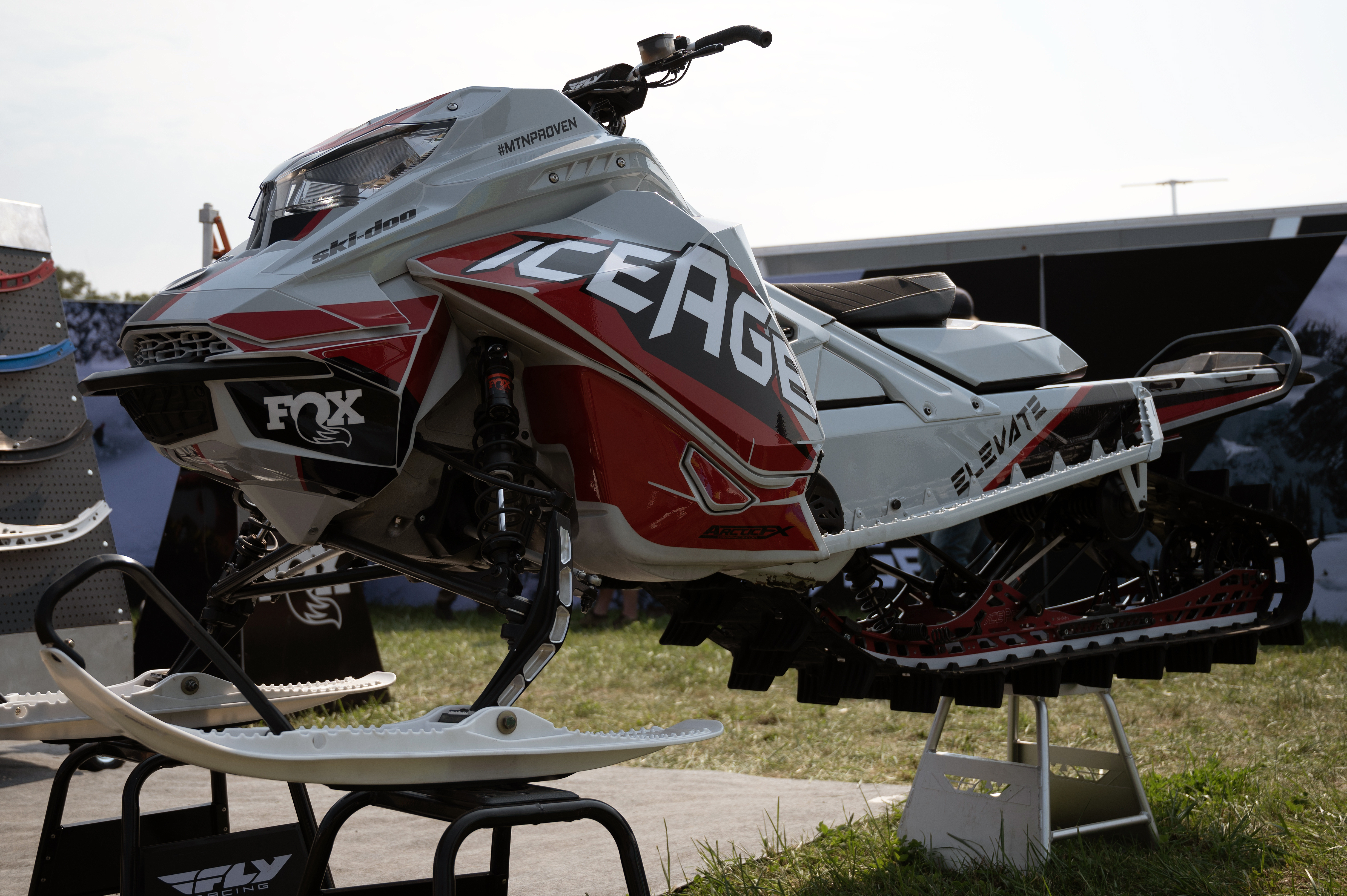 A Ski-Doo Gen4 Lightweight snowmobile with a gray, red, and black Klim F5 Ion custom vinyl wrap.