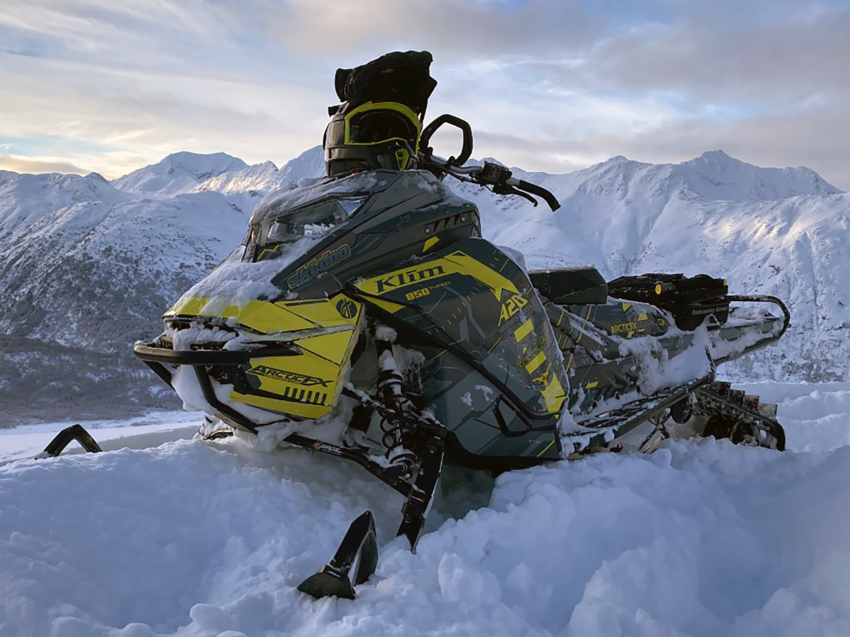 A Ski-Doo Gen4 Lightweight snowmobile with a gray and yellow Klim Recoil custom vinyl wrap.