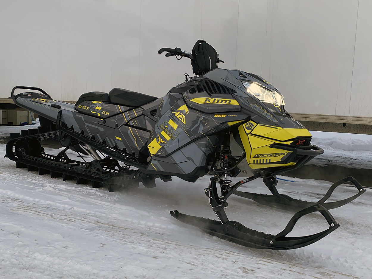 A Ski-Doo Gen4 Lightweight snowmobile with a gray and yellow Klim Recoil custom vinyl wrap.