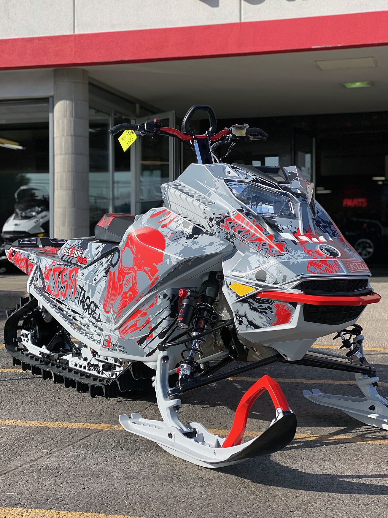 A Ski-Doo Gen4 Lightweight snowmobile with a white, red, and gray Tagged custom vinyl wrap.