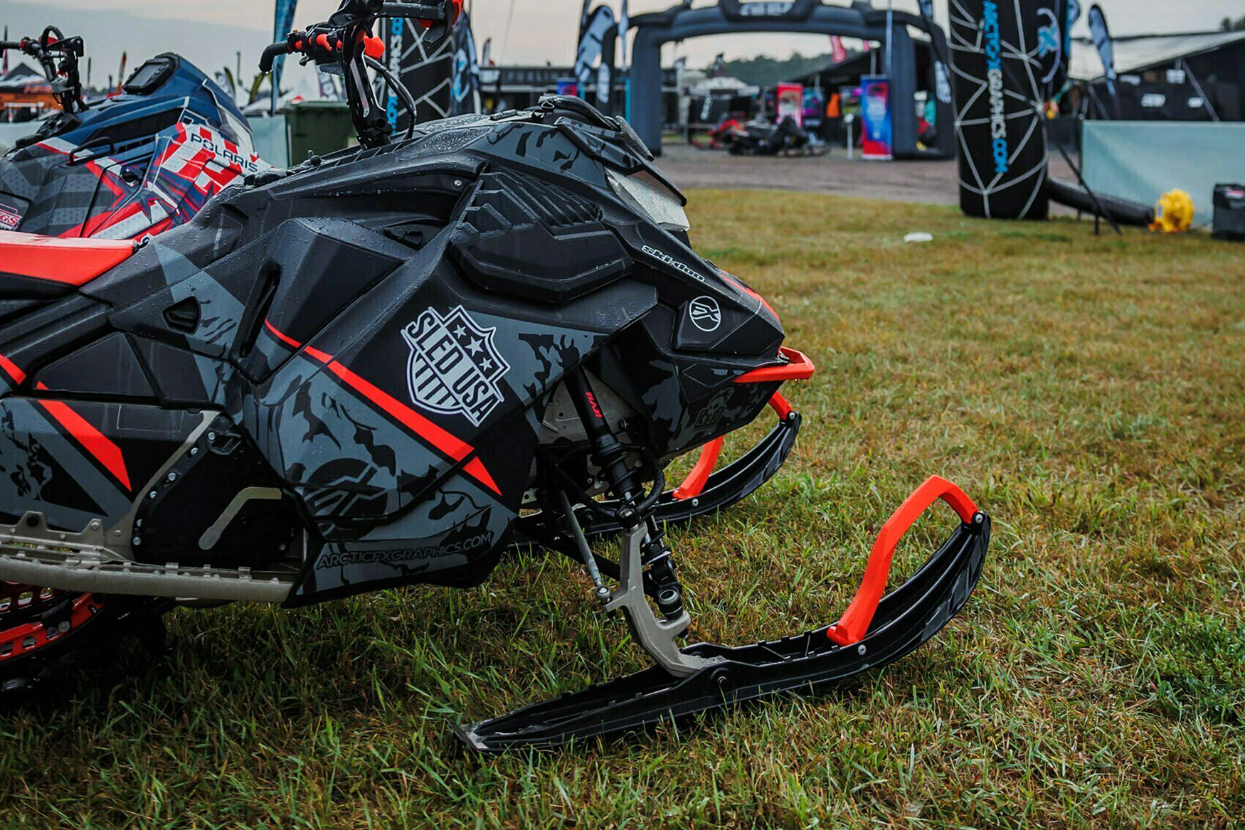 A Ski-Doo Gen4 Lightweight snowmobile with a black, red, and gray Turcotte Syndicate custom vinyl wrap.