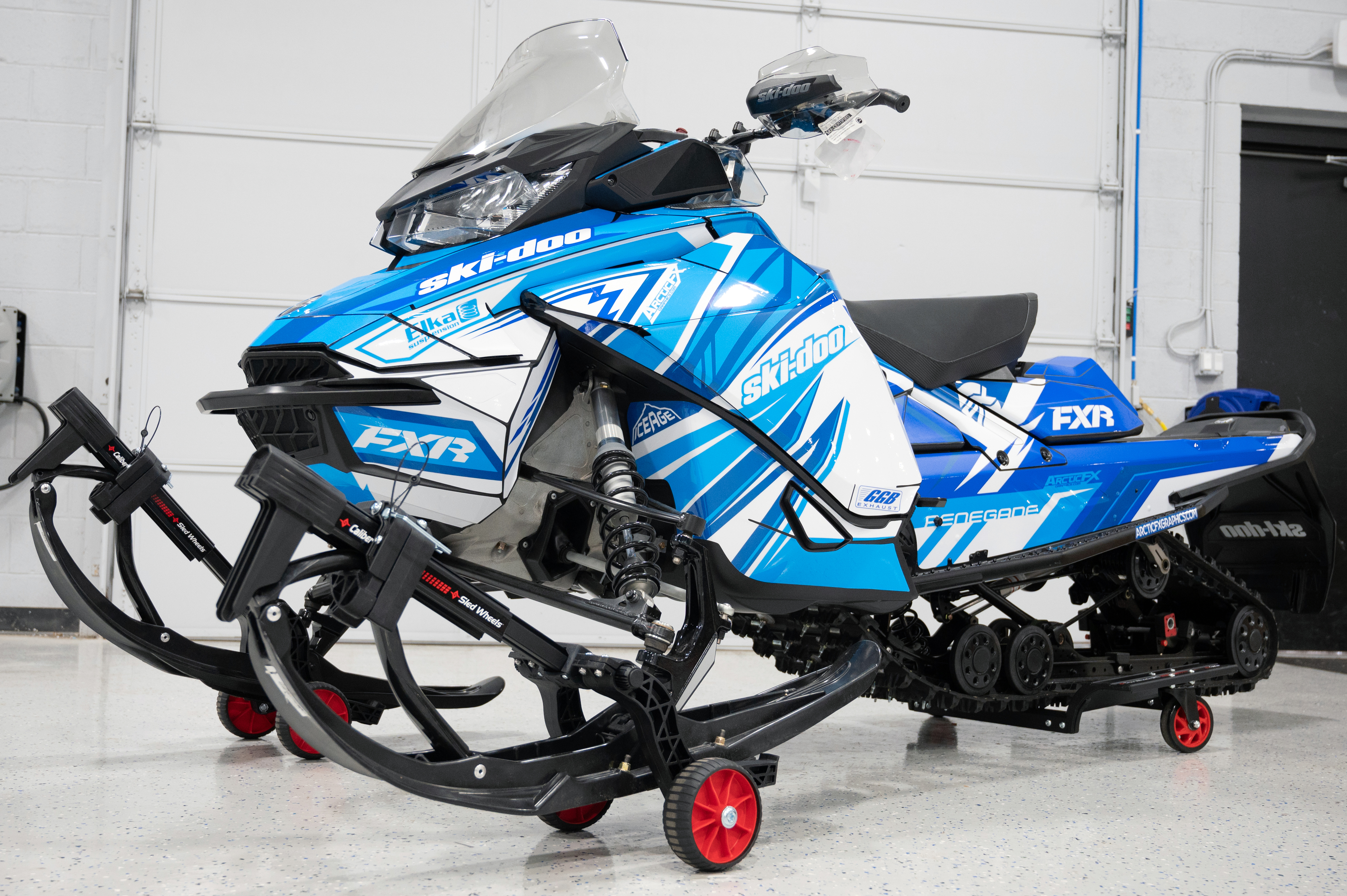 A Ski-Doo Gen4 Narrow Body snowmobile with a octane, white, and blue Kesterke Adrenaline custom vinyl wrap.