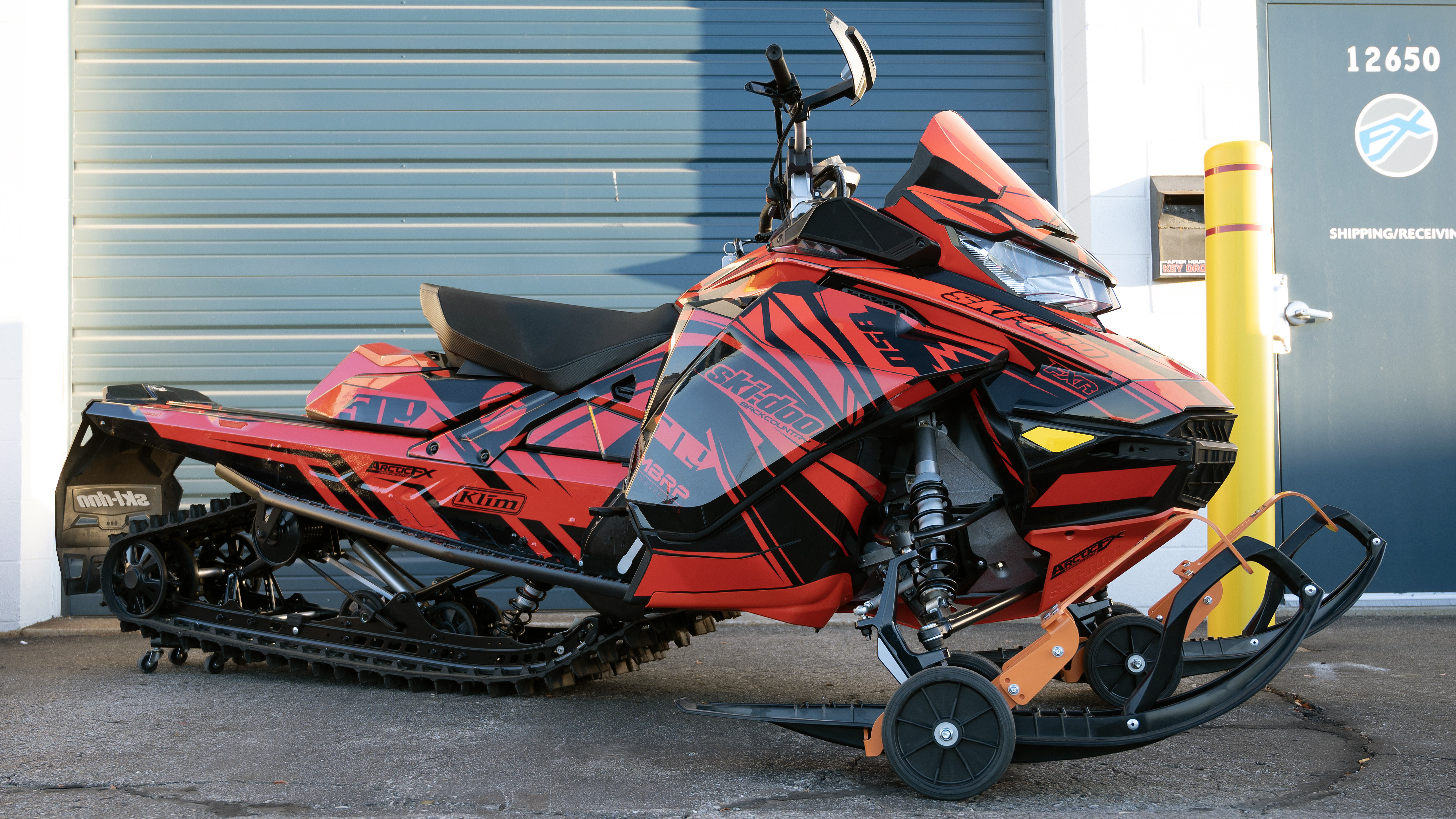 A Ski-Doo Gen4 Narrow Body snowmobile with a red and black Kesterke Adrenaline custom vinyl wrap.