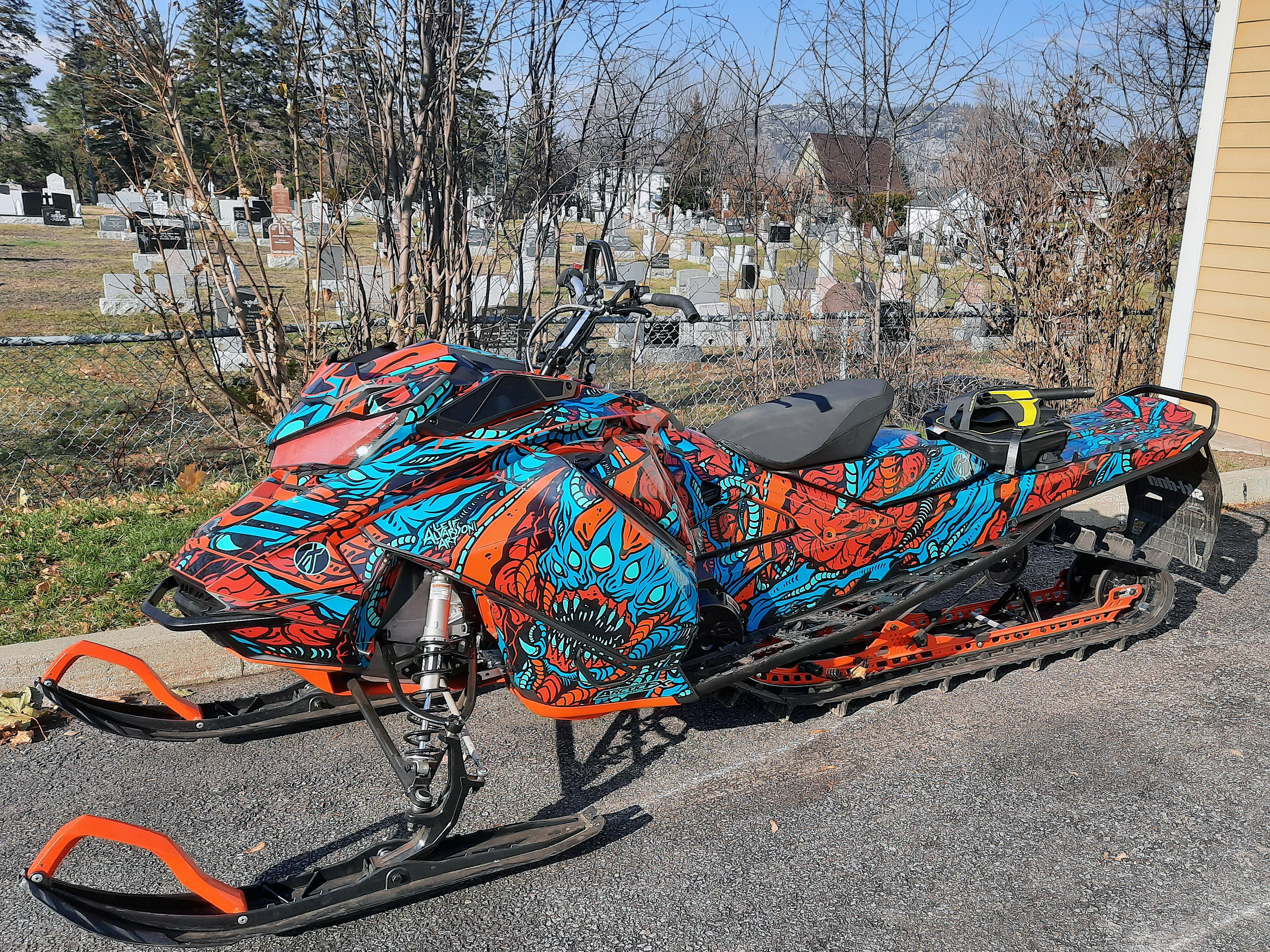 A Ski-Doo Gen4 Narrow Body snowmobile with a octane blue, red, and black Leif Alvarsson Area 51 custom vinyl wrap.