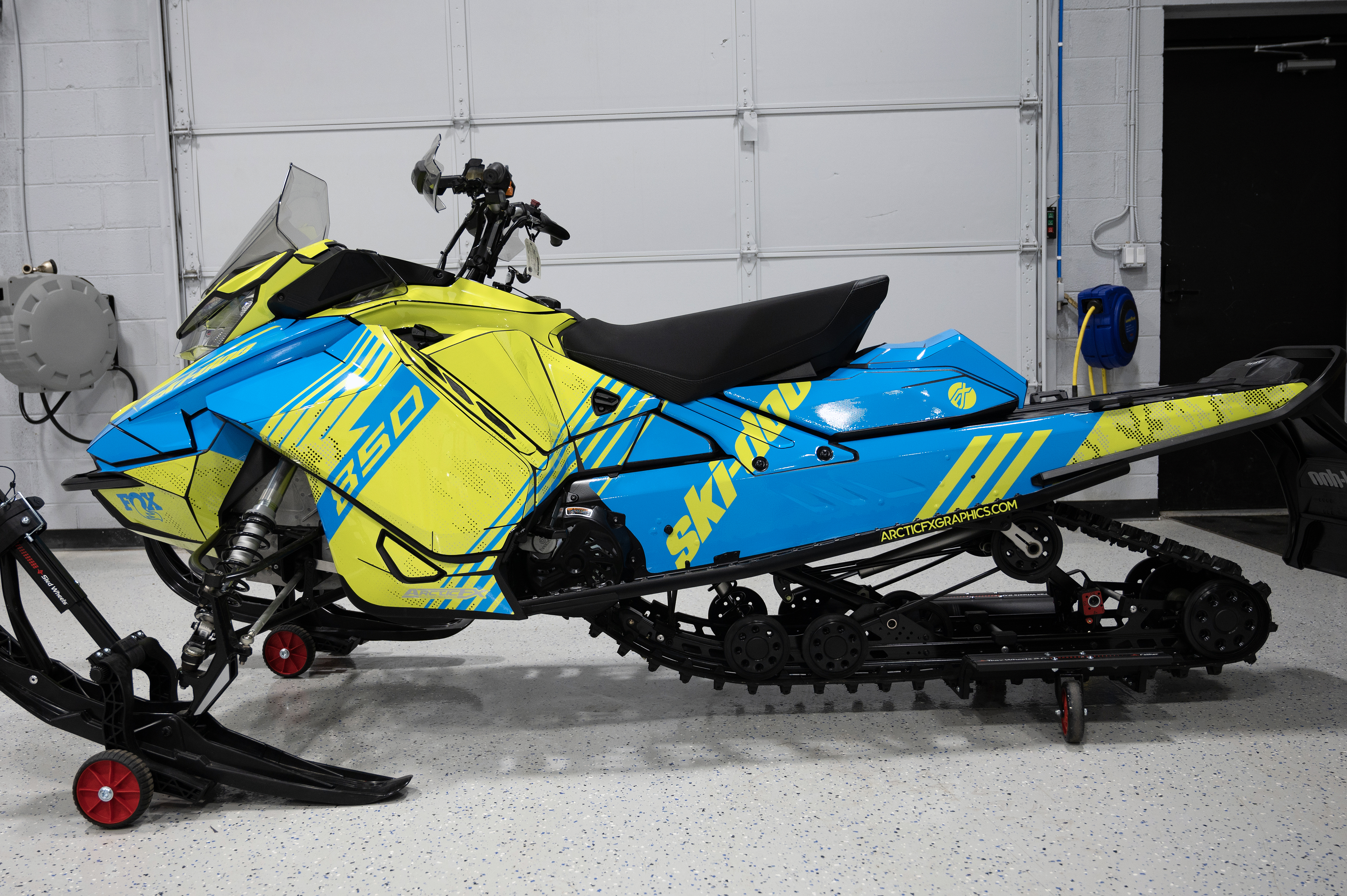 A Ski-Doo Gen4 Narrow Body snowmobile with a blue and yellow Armada custom vinyl wrap.