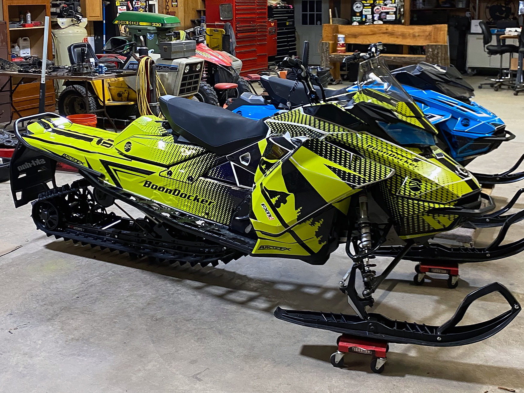 A Ski-Doo Gen4 Narrow Body snowmobile with a black and yellow BD Spooled custom vinyl wrap.