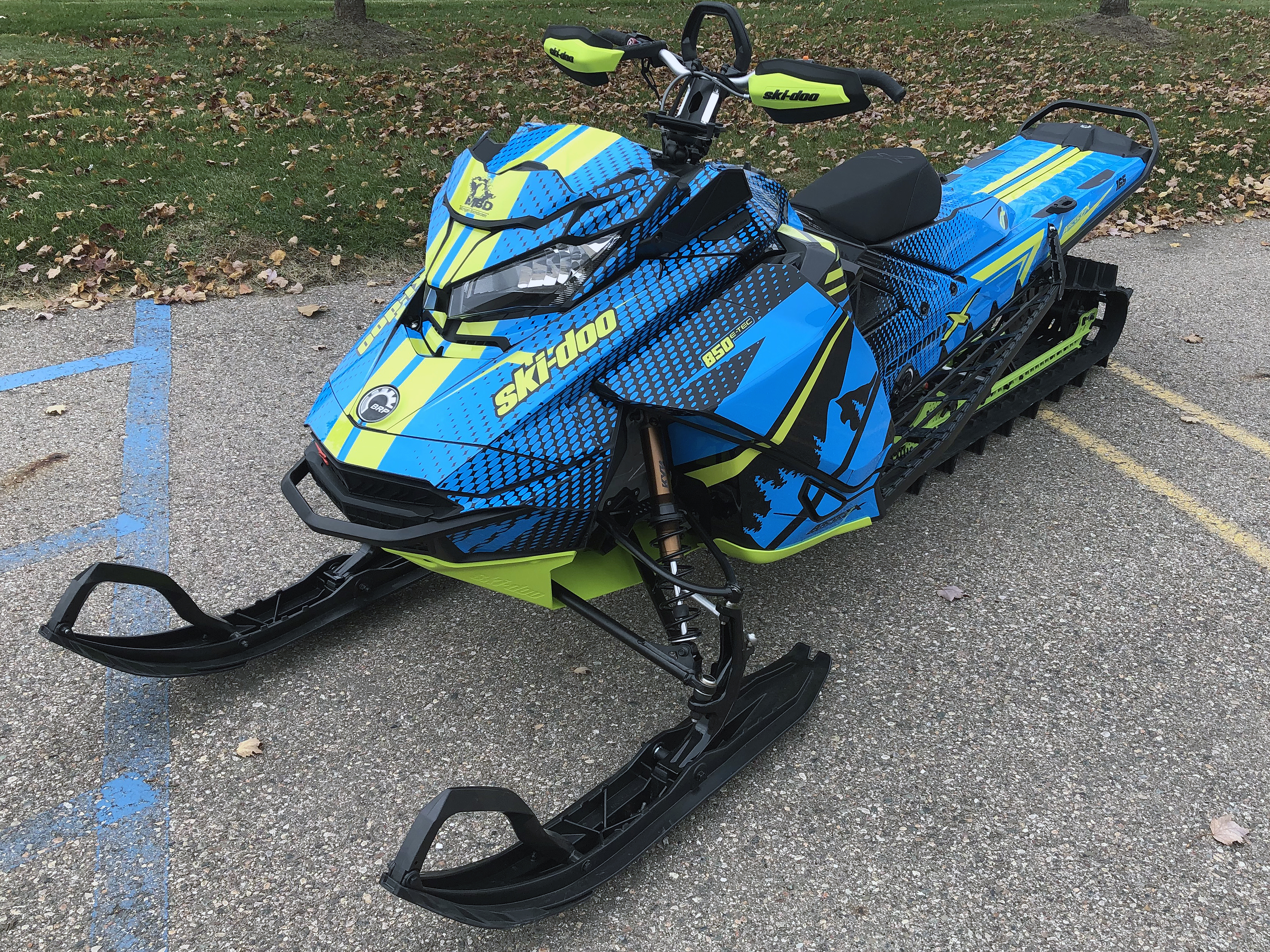 A Ski-Doo Gen4 Narrow Body snowmobile with a octane blue, manta, and black BD Spooled custom vinyl wrap.