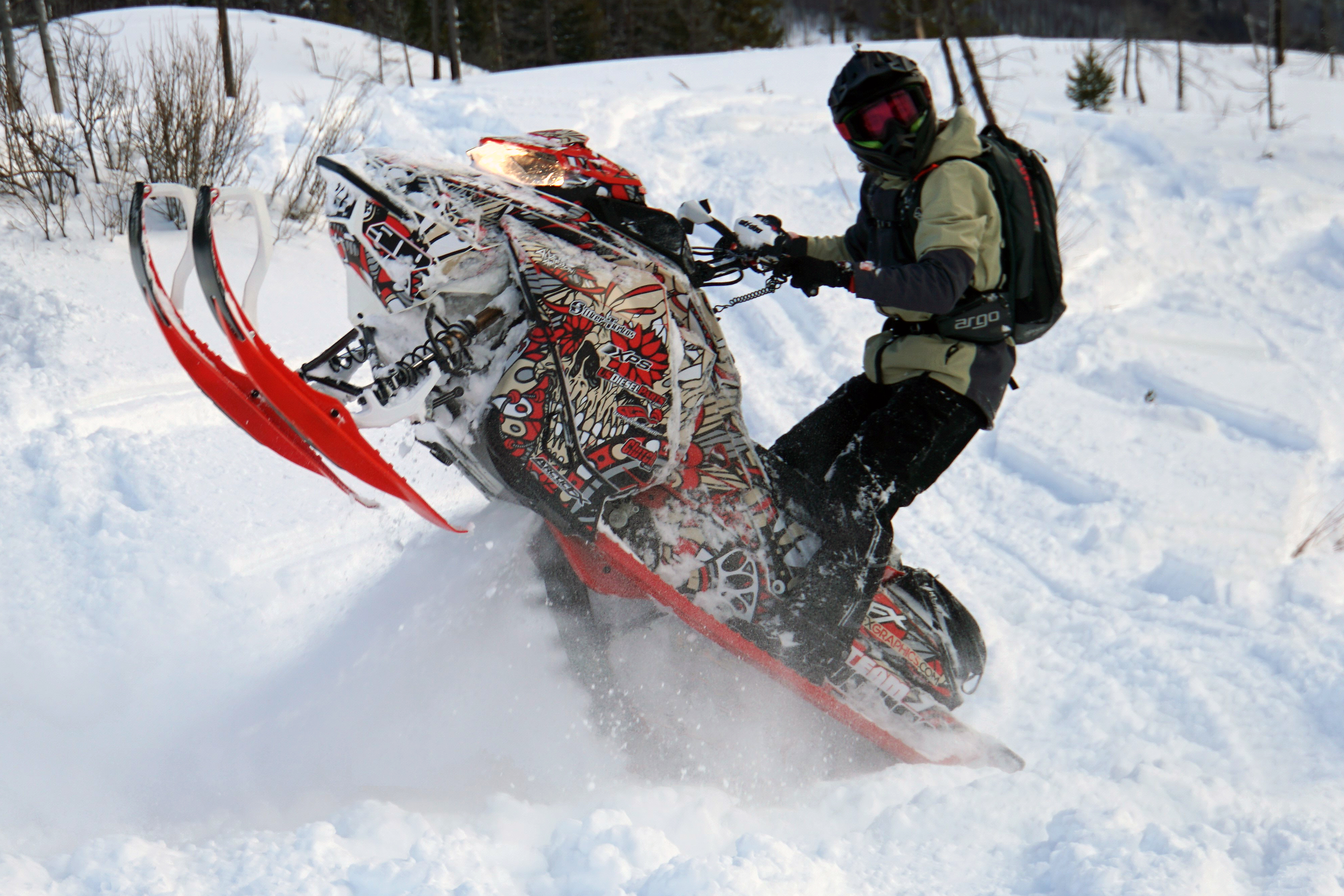 A Ski-Doo Gen4 Narrow Body snowmobile with a red, tan, and black Leif Alvarsson Calavera custom vinyl wrap.