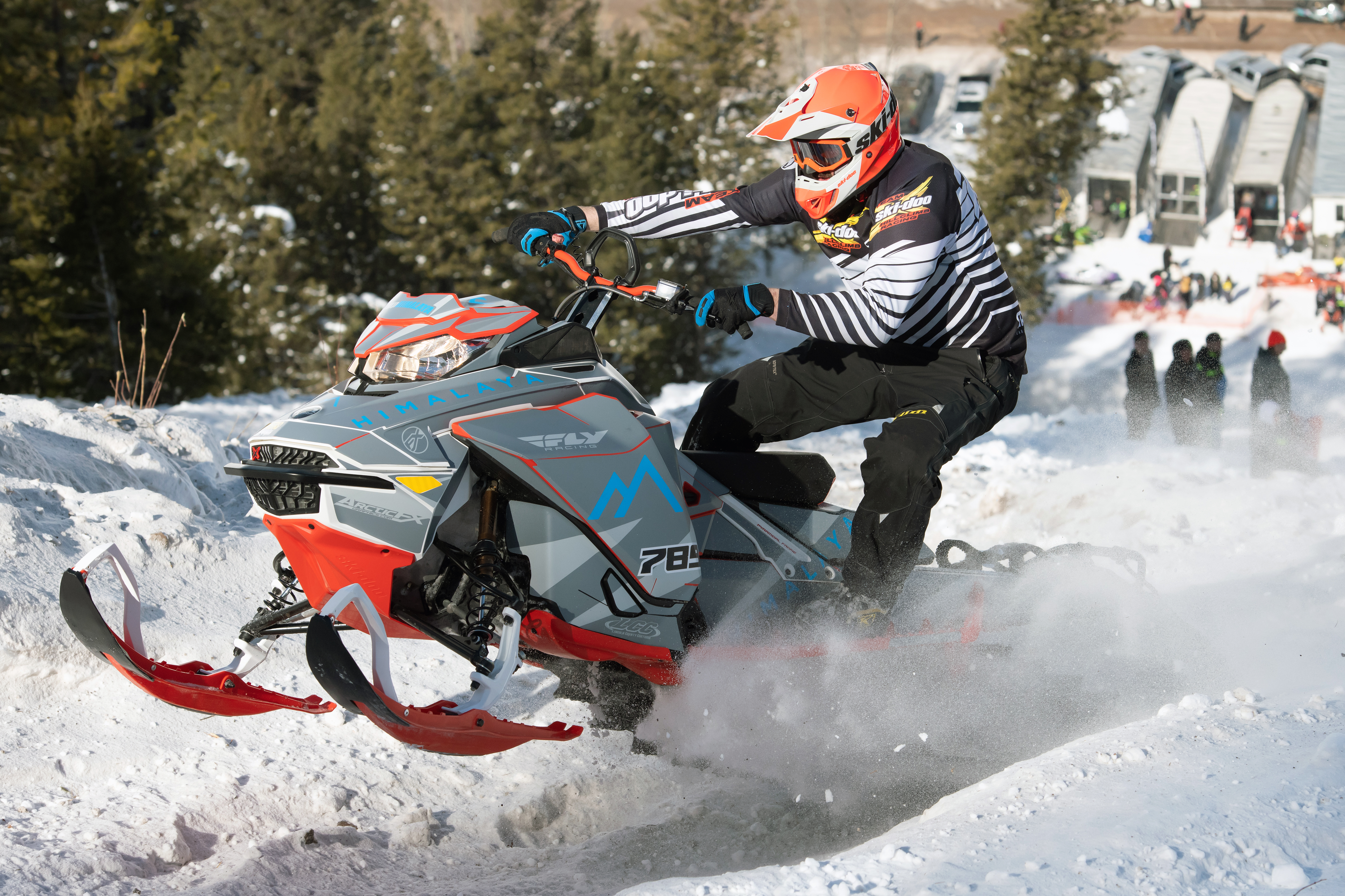 A Ski-Doo Gen4 Narrow Body snowmobile with a gray and blue Burandt Evolution custom vinyl wrap.