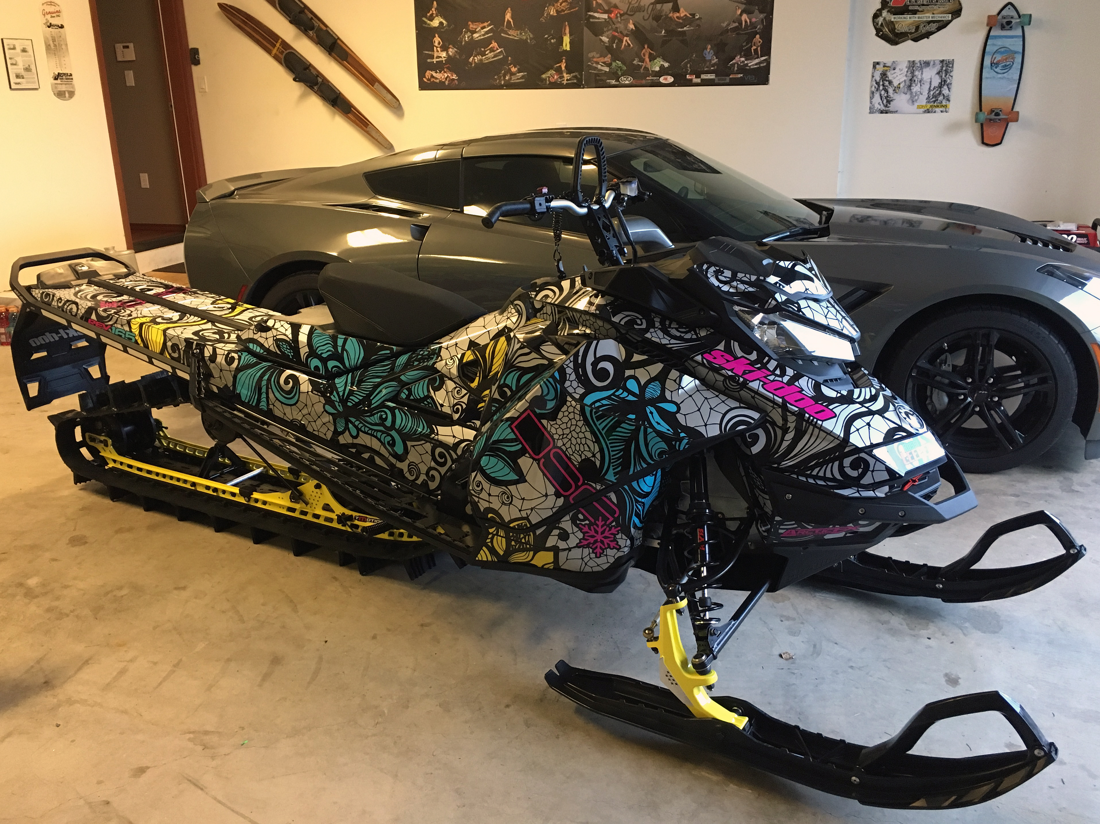 A Ski-Doo Gen4 Narrow Body snowmobile with a blue, gray, and pink Flower and Lace custom vinyl wrap.