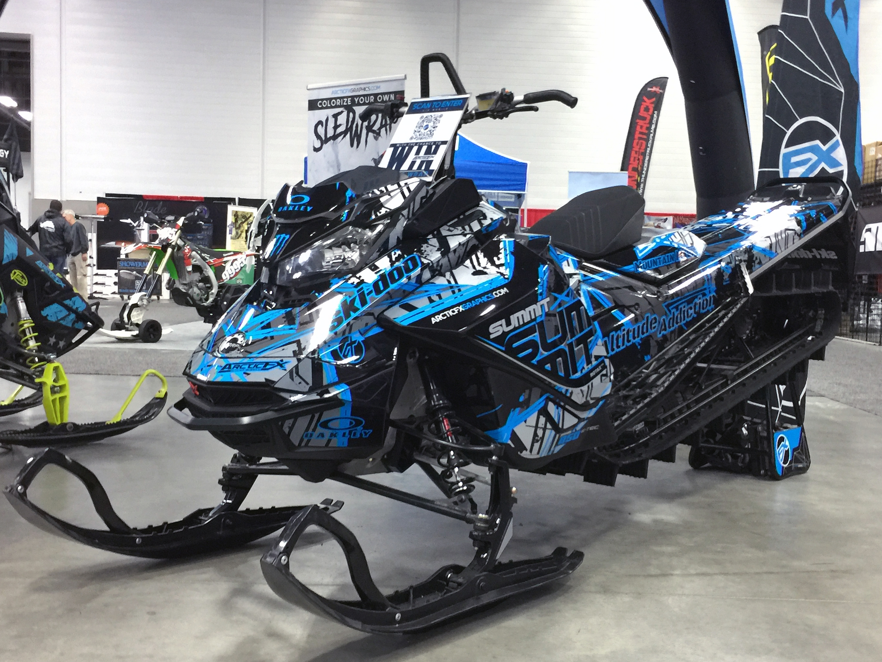 A Ski-Doo Gen4 Narrow Body snowmobile with a black, gray, and blue Havoc custom vinyl wrap.