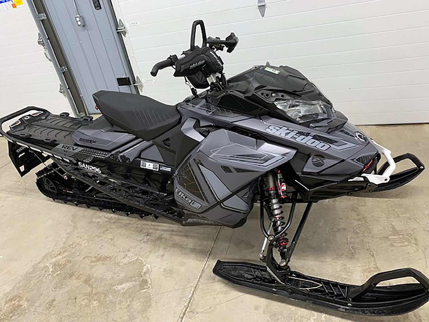 A Ski-Doo Gen4 Narrow Body snowmobile with a gray and black Rogue custom vinyl wrap.