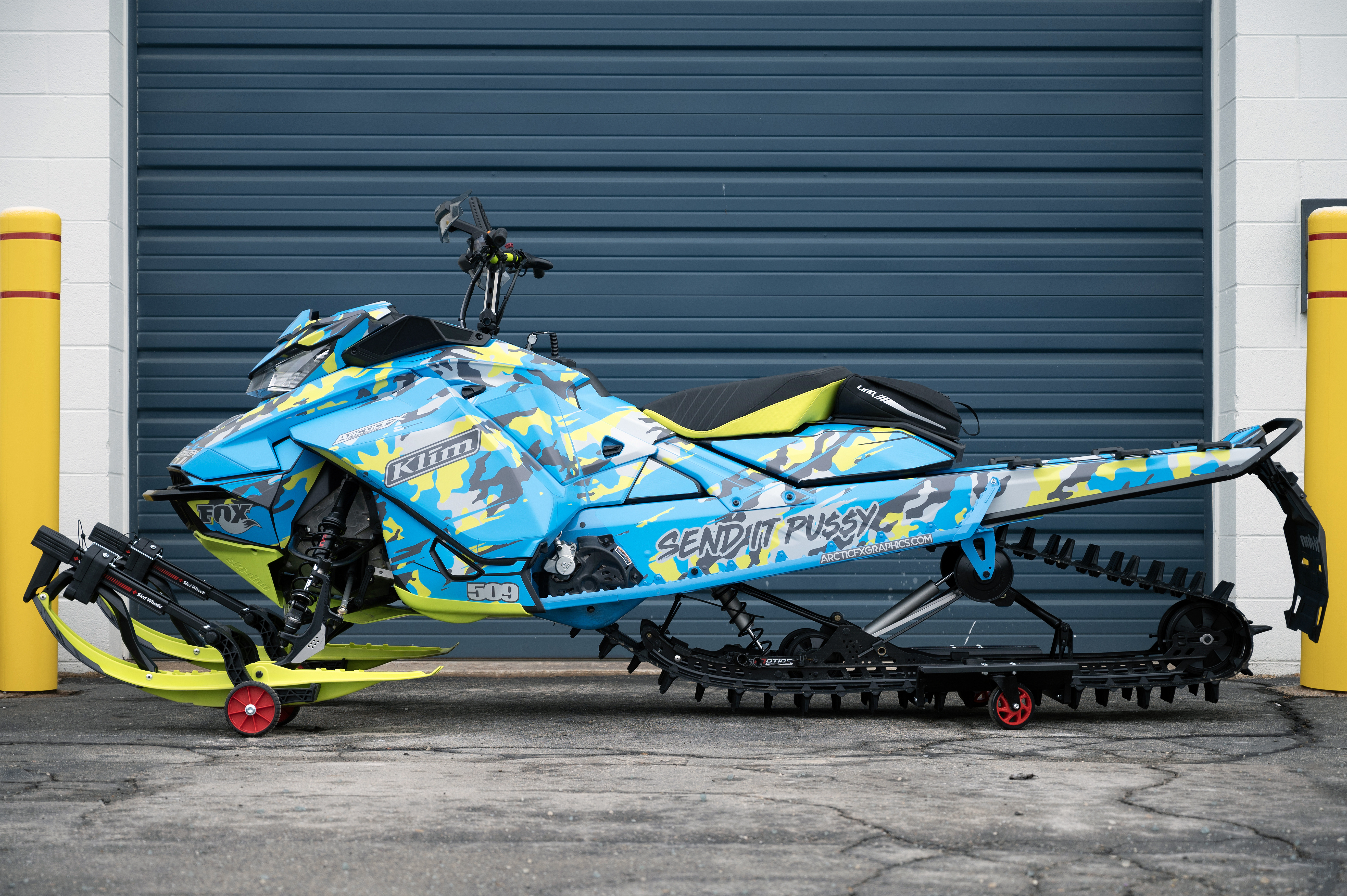 A Ski-Doo Gen4 Narrow Body snowmobile with a gray, manta, and octane blue RR Camo custom vinyl wrap.