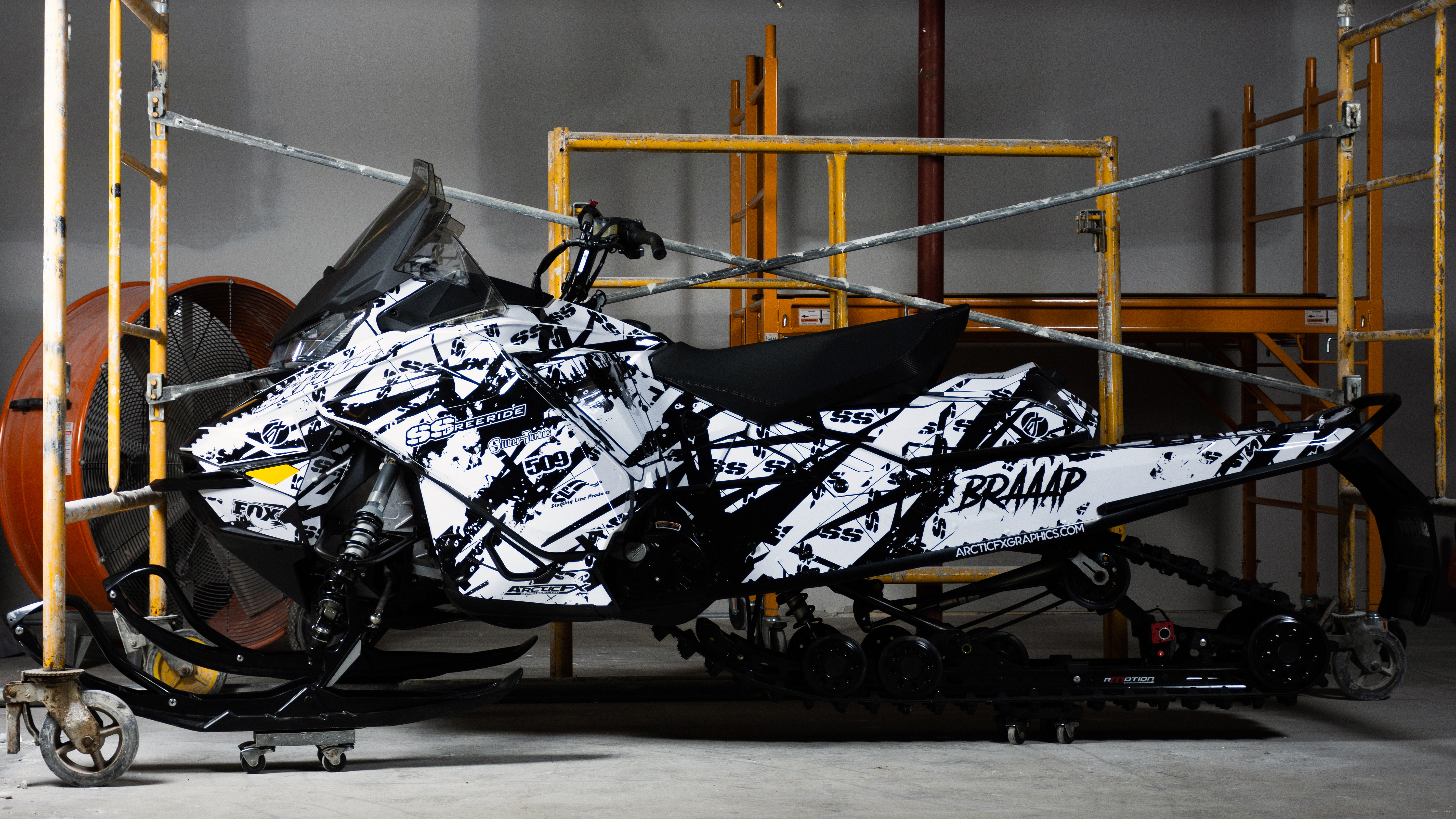 A Ski-Doo Gen4 Narrow Body snowmobile with a white and black Skinner Aftermath custom vinyl wrap.