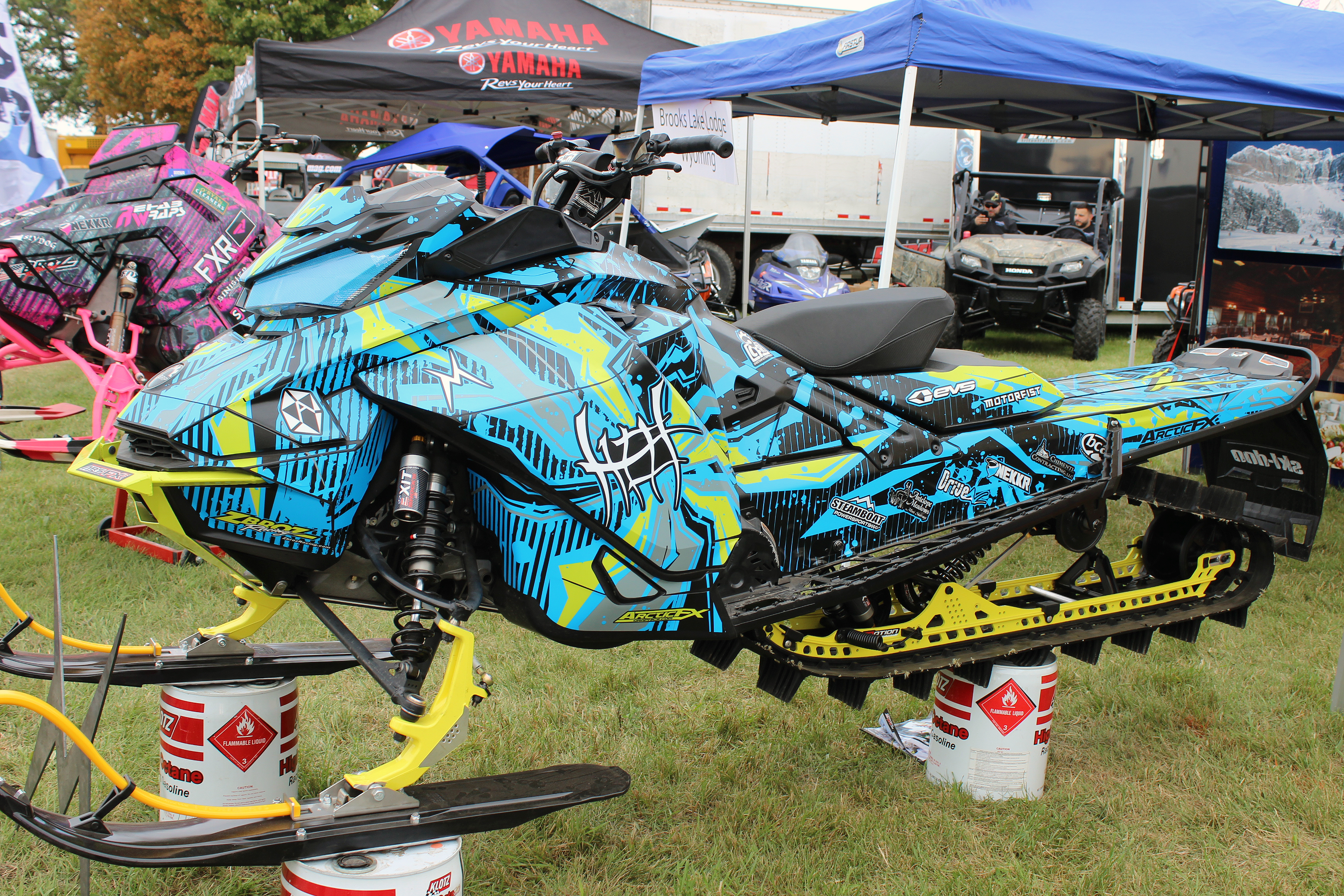 A Ski-Doo Gen4 Narrow Body snowmobile with a octane blue, manta, and black Stricken custom vinyl wrap.