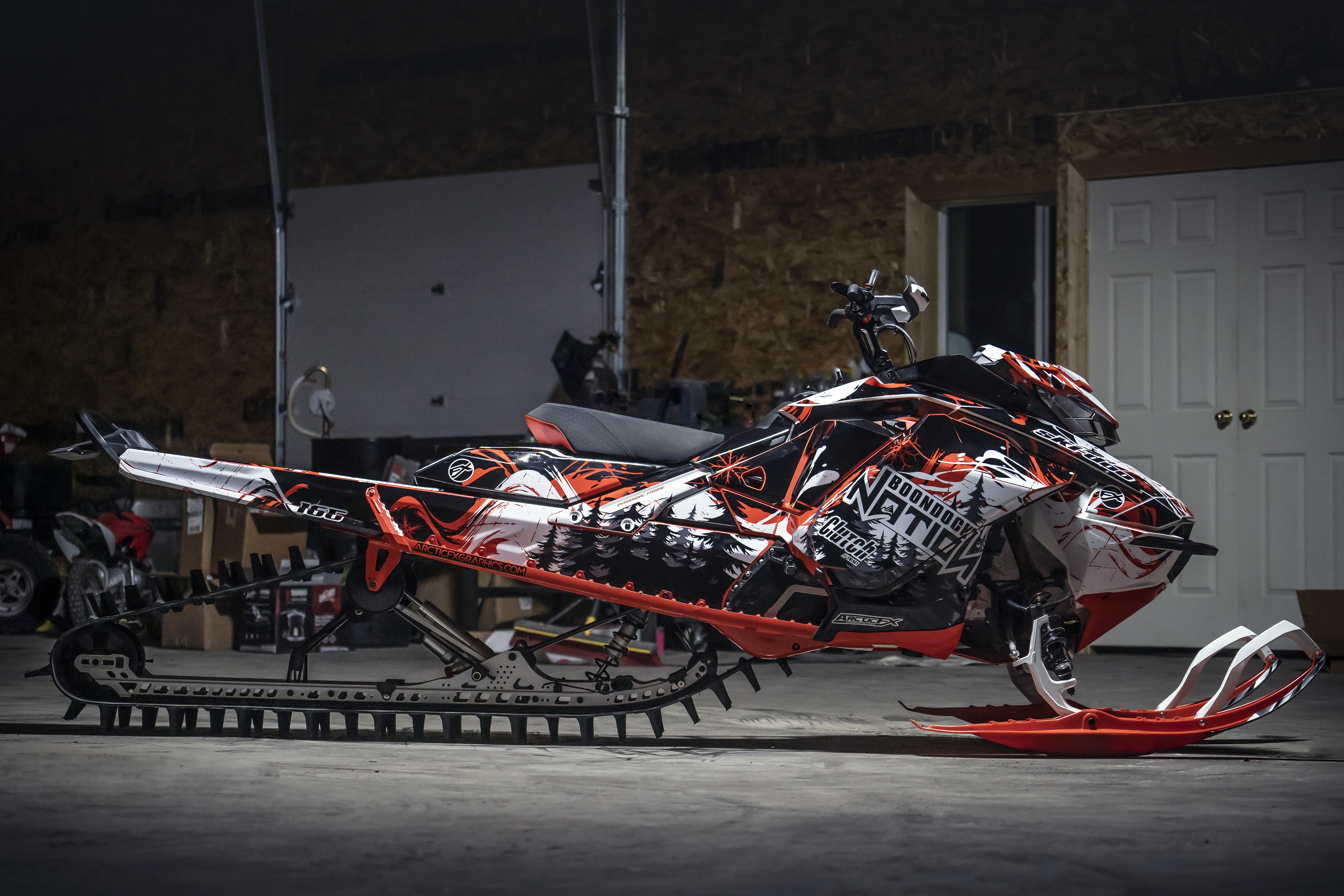 A Ski-Doo Gen4 Narrow Body snowmobile with a white, red, and black Sub Zero custom vinyl wrap.