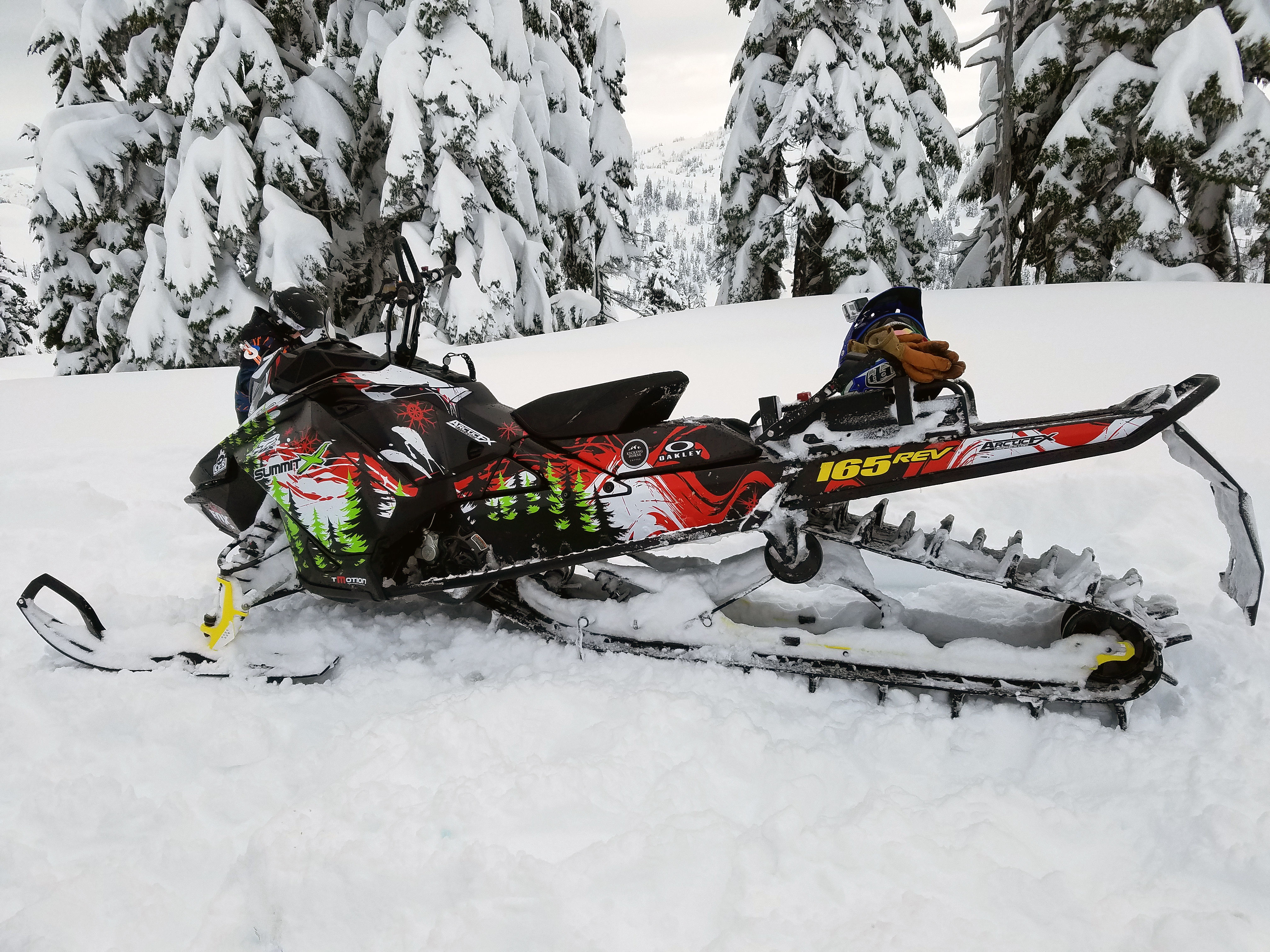 A Ski-Doo Gen4 Narrow Body snowmobile with a white, red, lime, and black Sub Zero custom vinyl wrap.