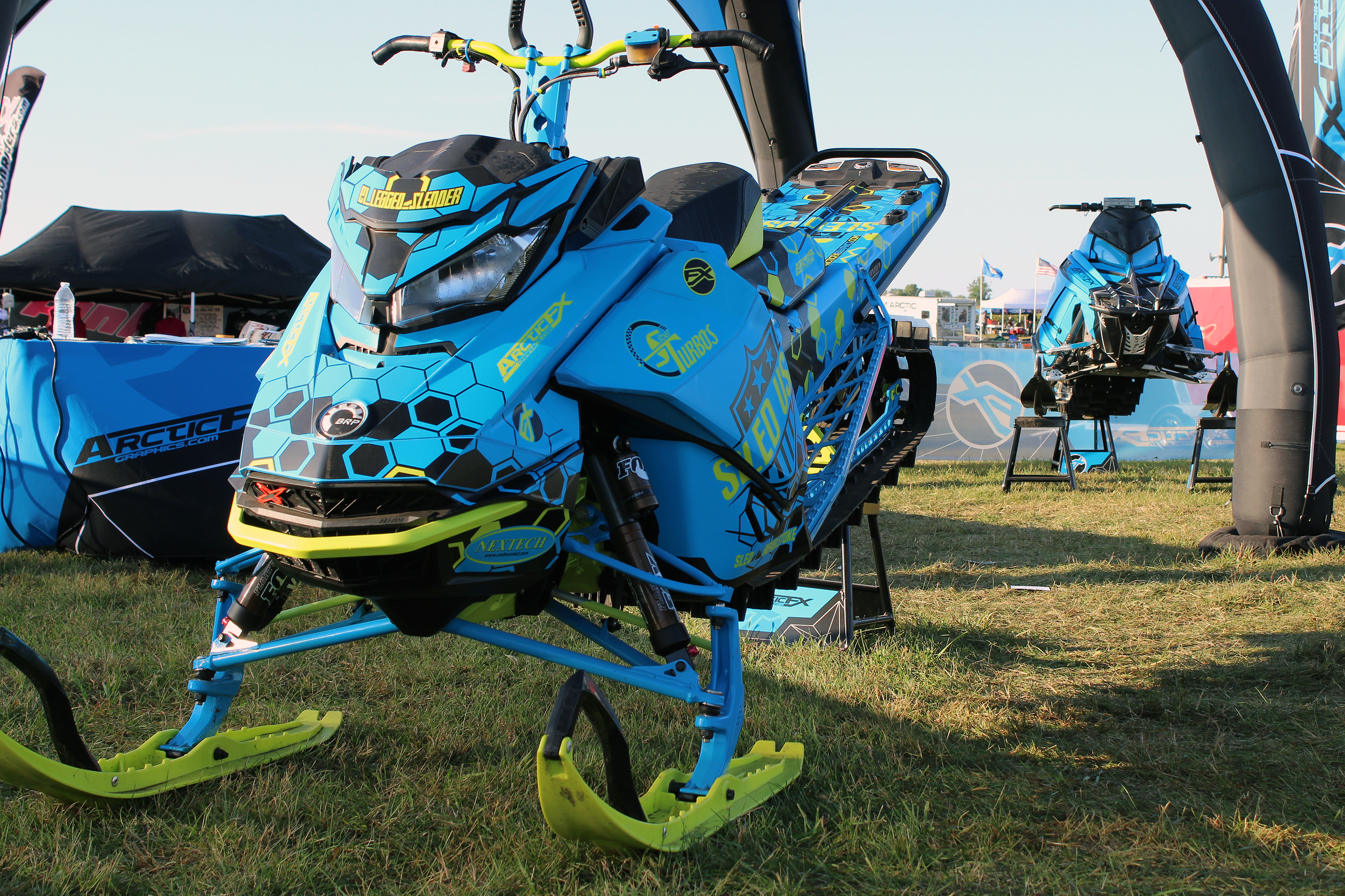 A Ski-Doo Gen4 Narrow Body snowmobile with a black, octane blue, and manta Sync custom vinyl wrap.