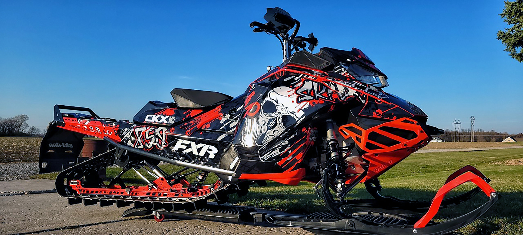 A Ski-Doo Gen4 Narrow Body snowmobile with a black, white, and red Tagged custom vinyl wrap.