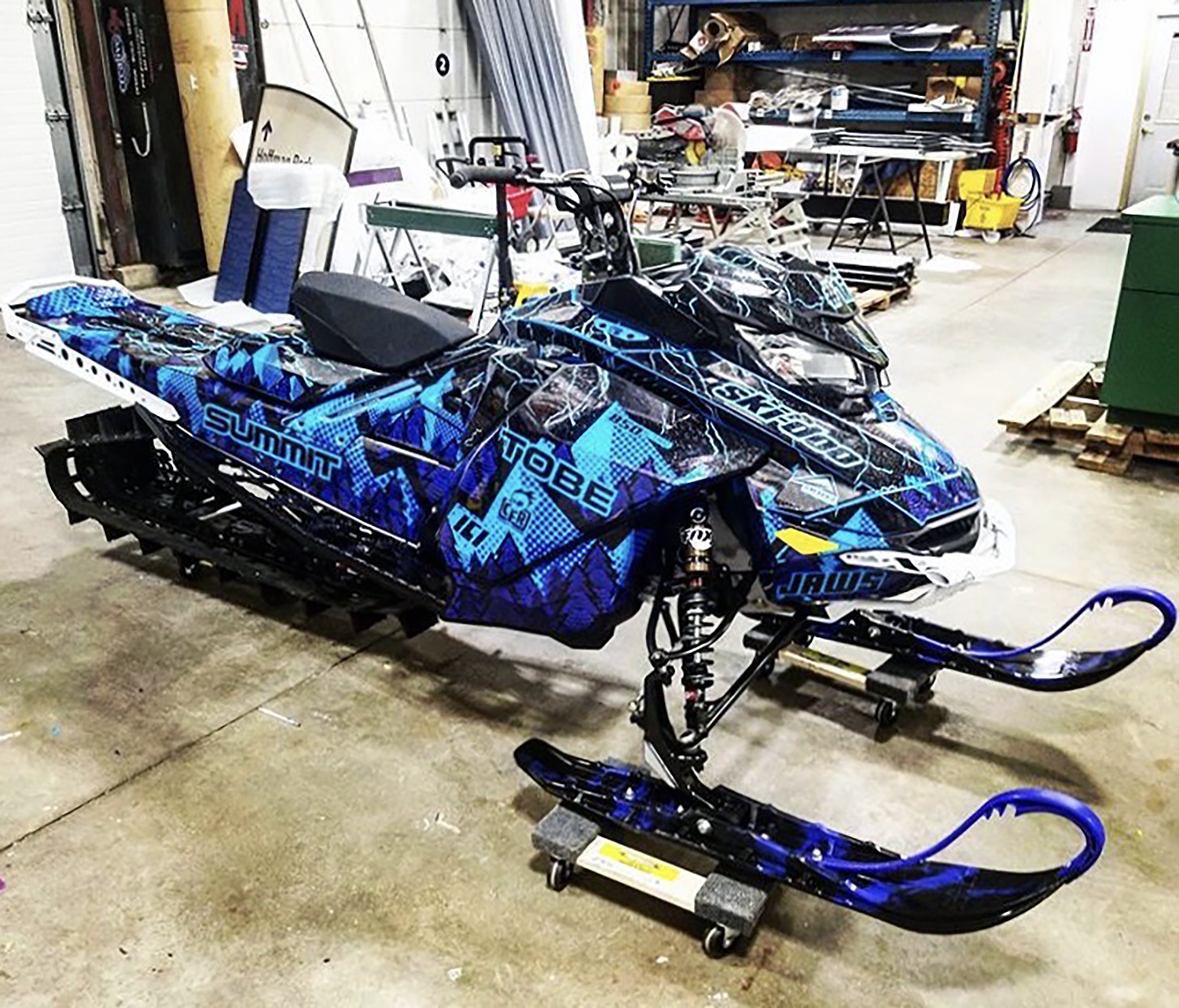 A Ski-Doo Gen4 Narrow Body snowmobile with a blue, black, and purple Vertex custom vinyl wrap.