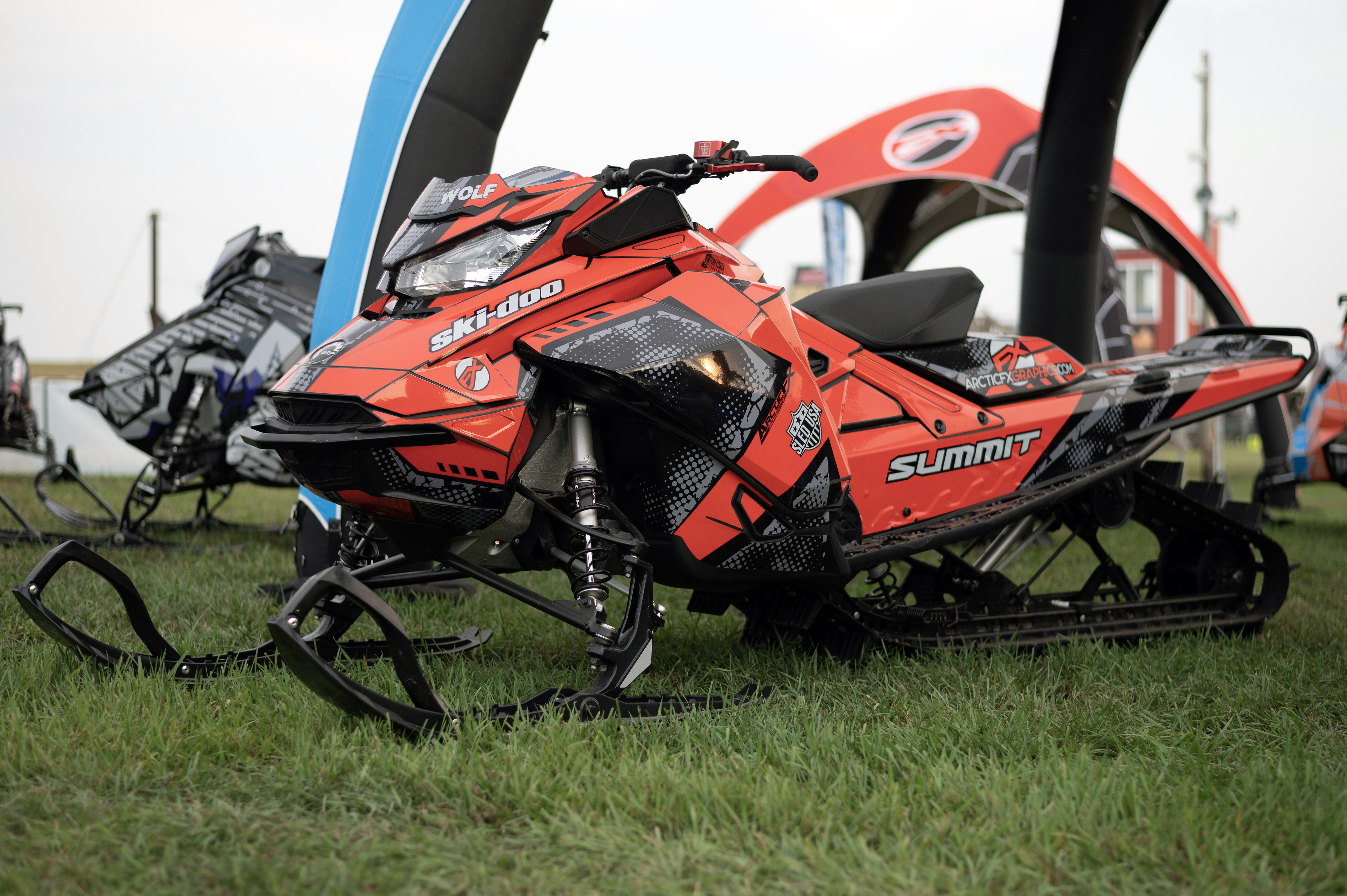 A Ski-Doo Gen4 Narrow Body snowmobile with a red, black, and gray Vision custom vinyl wrap.