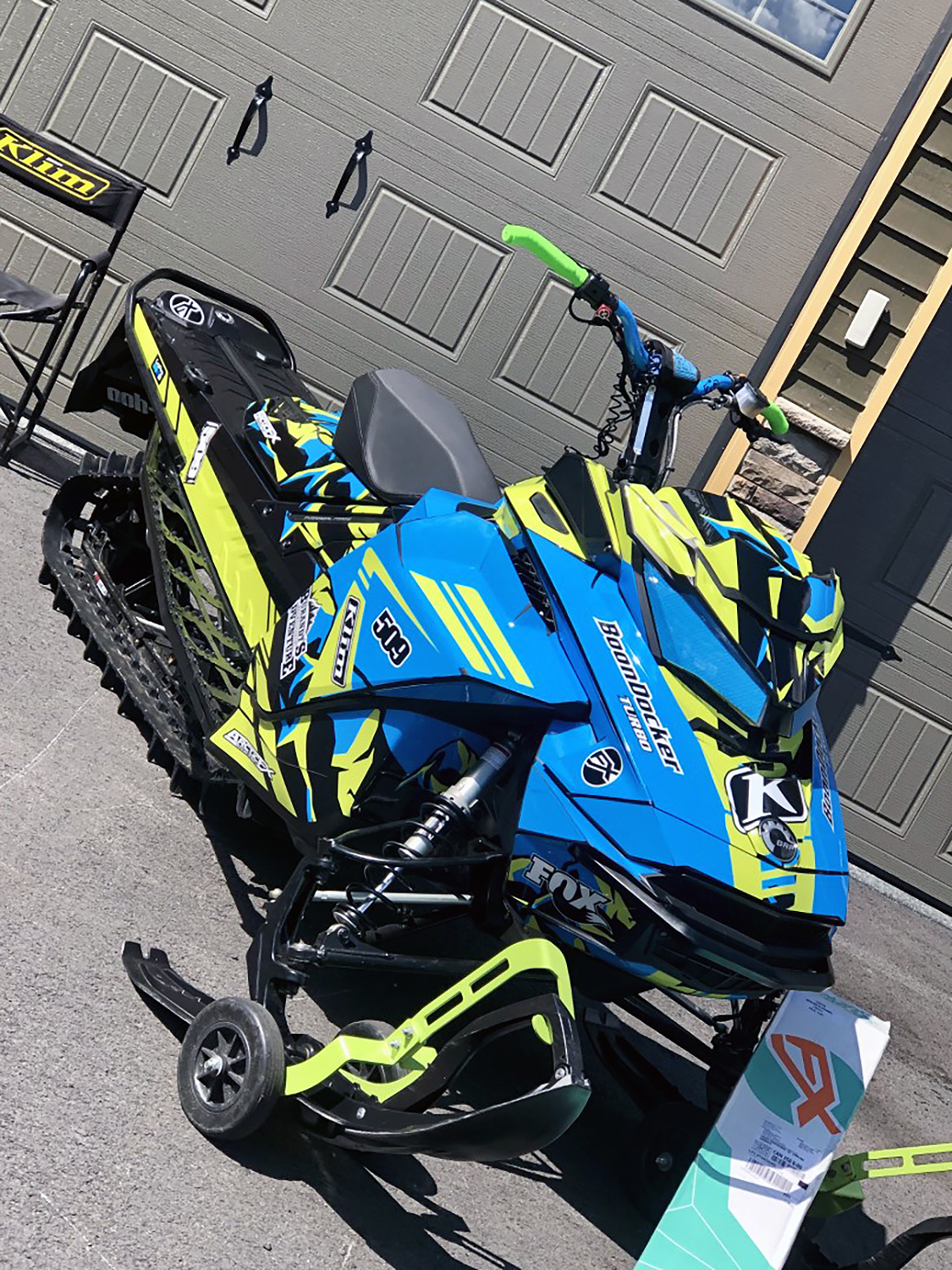 A Ski-Doo Gen4 Narrow Body snowmobile with a octane blue, manta, and white Burandt Vista custom vinyl wrap.