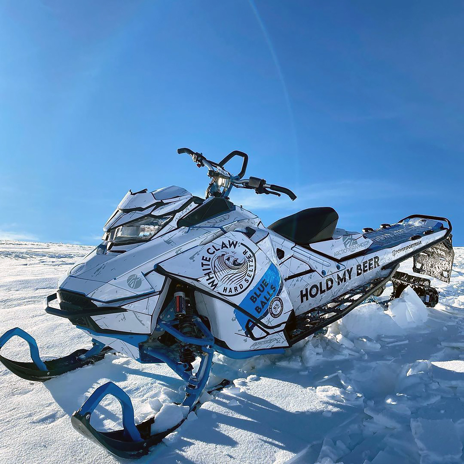 A Ski-Doo Gen4 Narrow Body snowmobile with a octane blue, white, and black White Claw beer custom vinyl wrap.