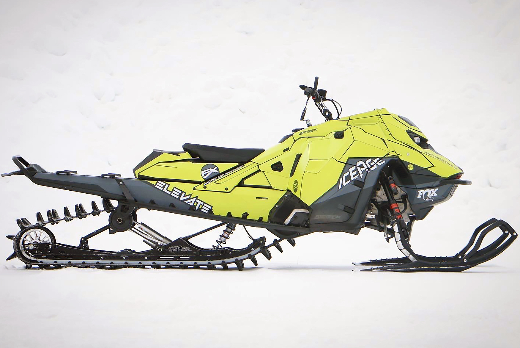 A Ski-Doo Gen5 Mountain snowmobile with a gray, black, and lime squeeze Ice Age custom vinyl wrap.