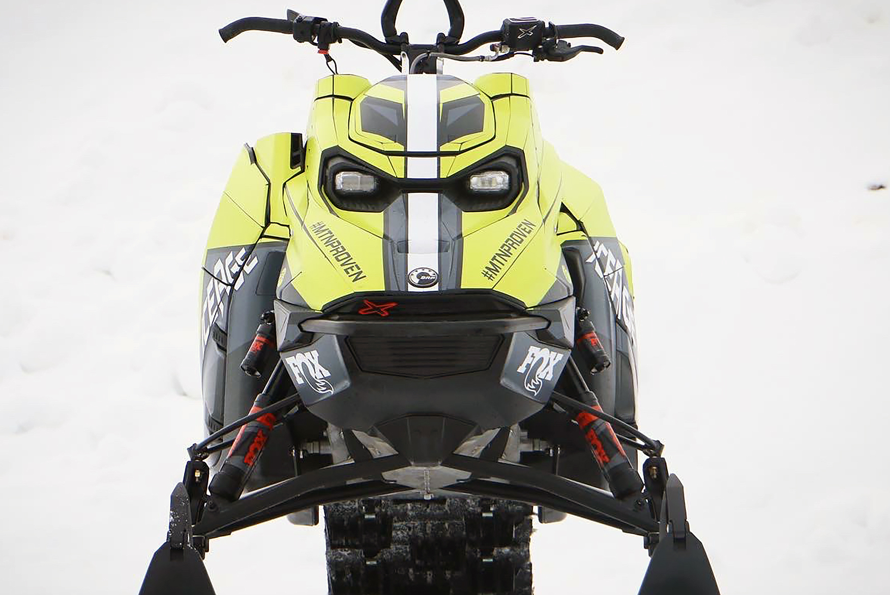 A Ski-Doo Gen5 Mountain snowmobile with a gray, black, and lime squeeze Ice Age custom vinyl wrap.