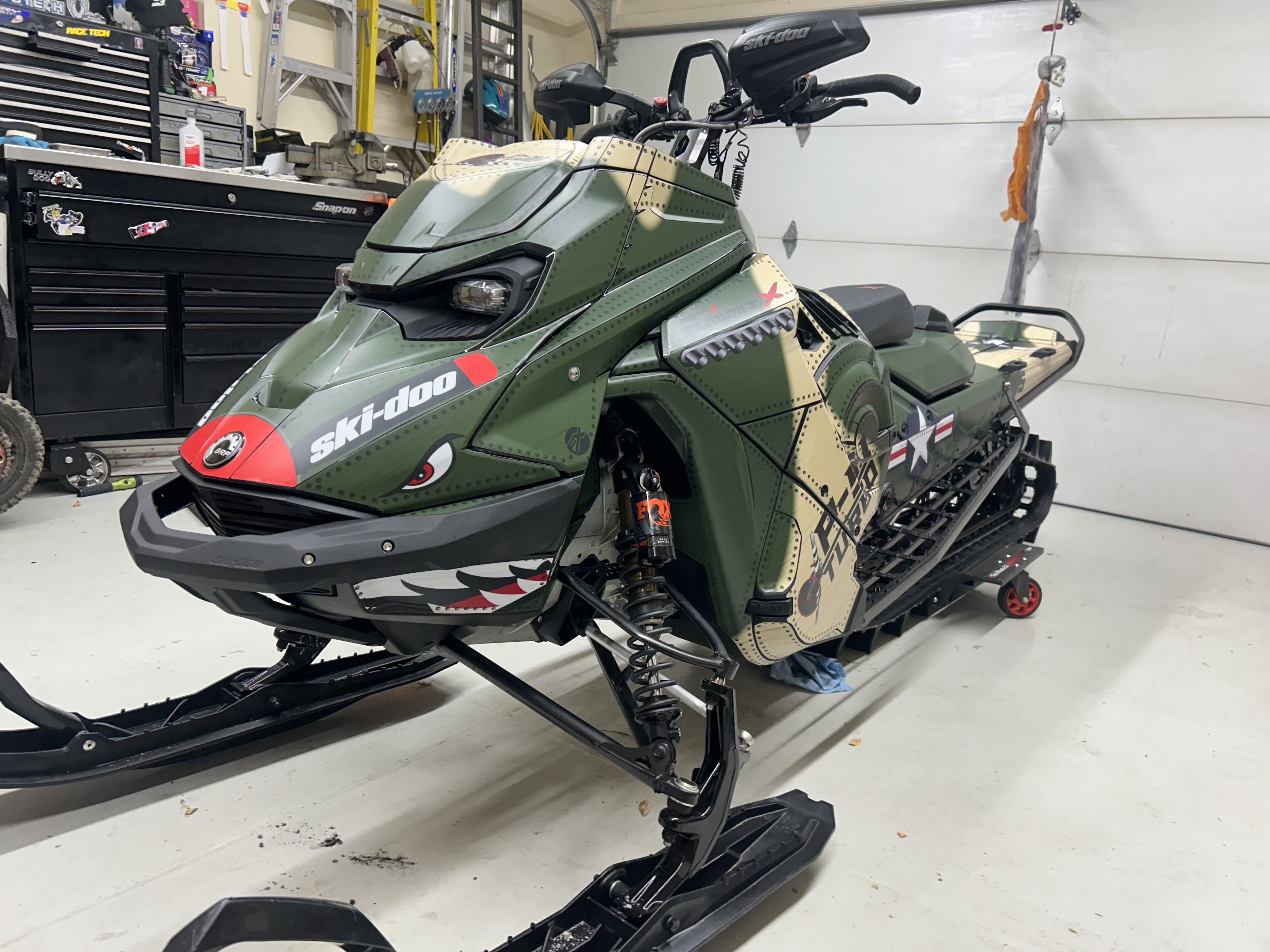 A Ski-Doo Gen5 Mountain snowmobile with a P-51 mustang custom vinyl wrap.