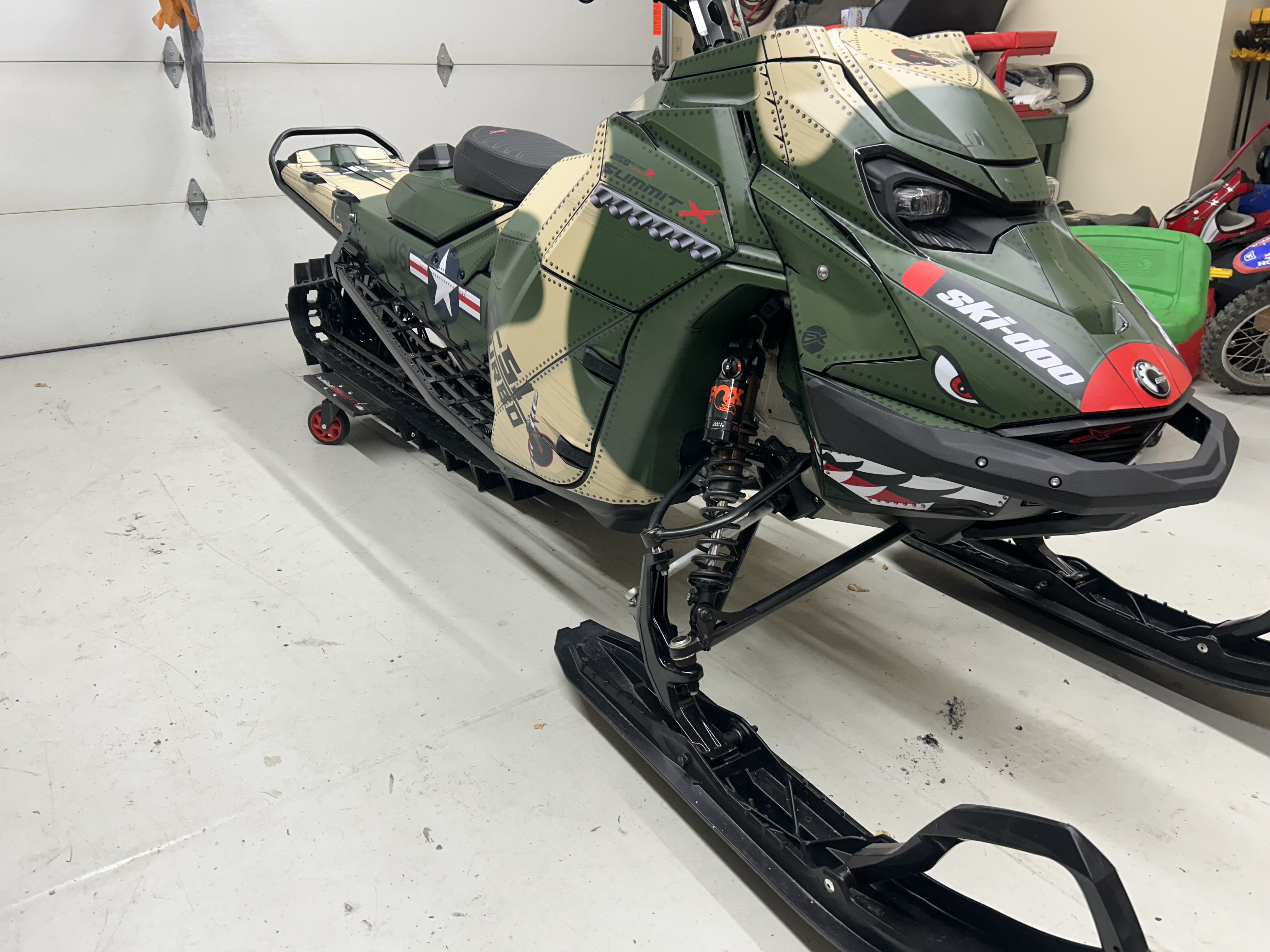A Ski-Doo Gen5 Mountain snowmobile with a P-51 mustang custom vinyl wrap.