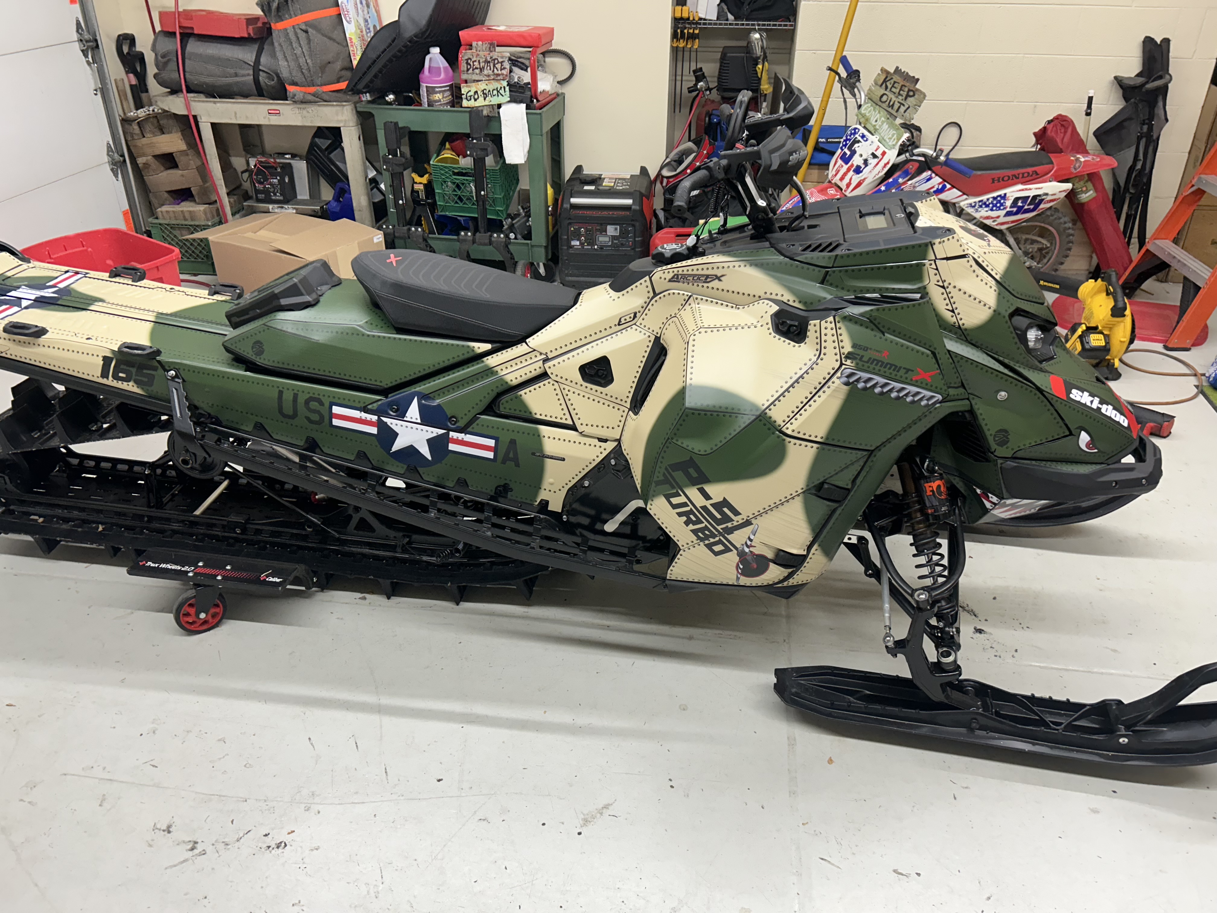 A Ski-Doo Gen5 Mountain snowmobile with a P-51 mustang custom vinyl wrap.