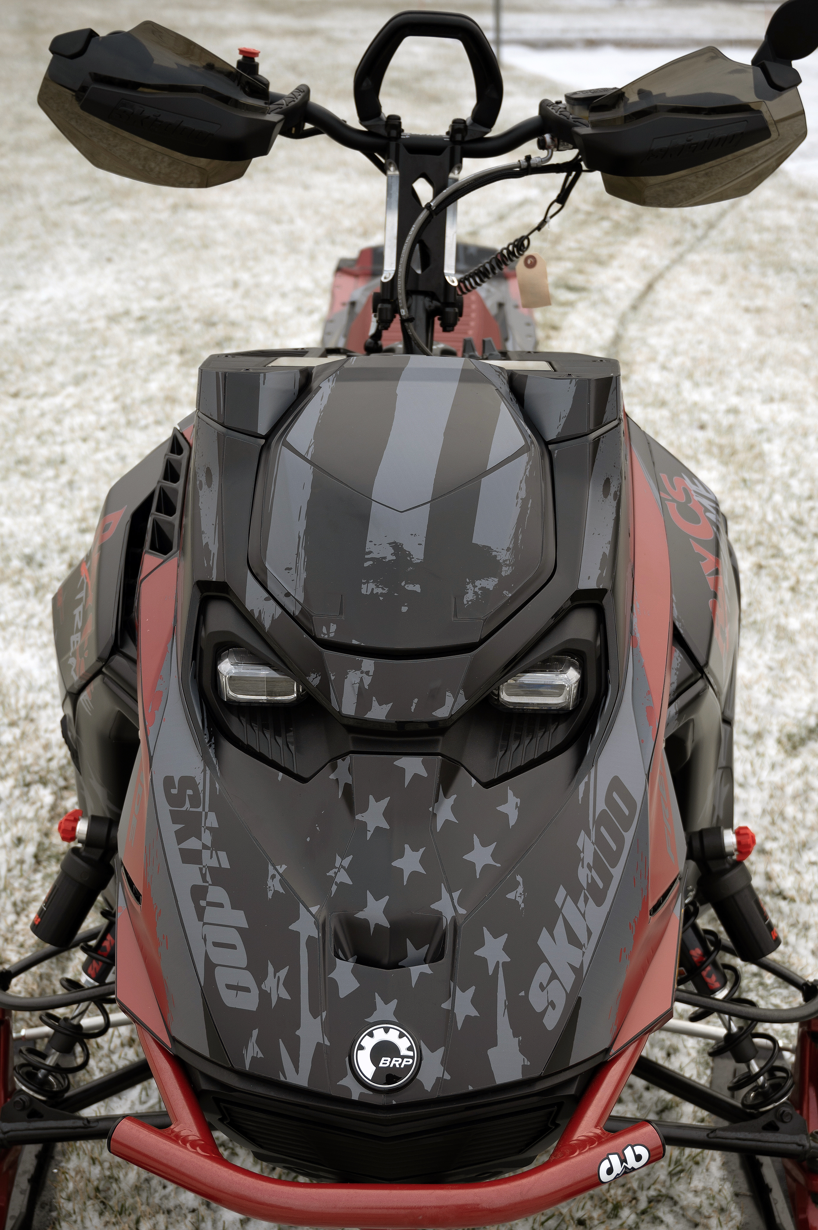 A Ski-Doo Gen5 Mountain snowmobile with a black, red, and gray RayC's American Flag custom vinyl wrap.