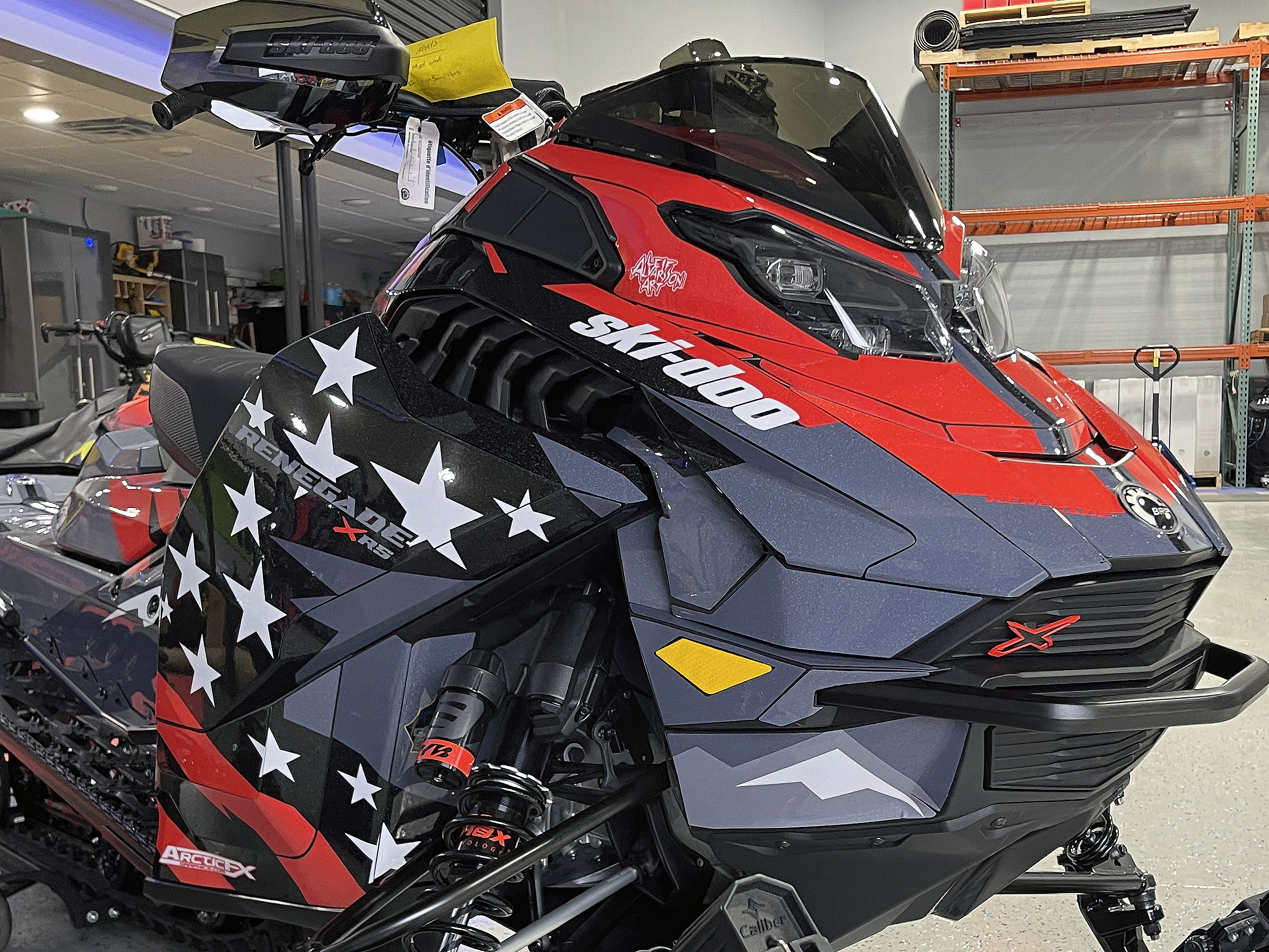 A Ski-Doo Gen5 Trail snowmobile with a red, white, and black Leif Alvarsson Merica custom vinyl wrap.