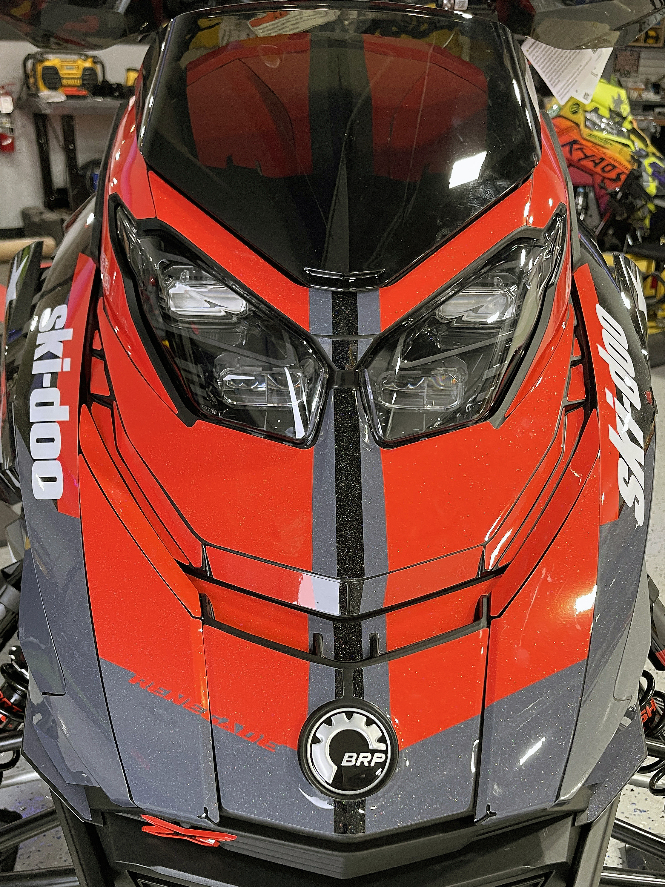 A Ski-Doo Gen5 Trail snowmobile with a red, white, and black Leif Alvarsson Merica custom vinyl wrap.