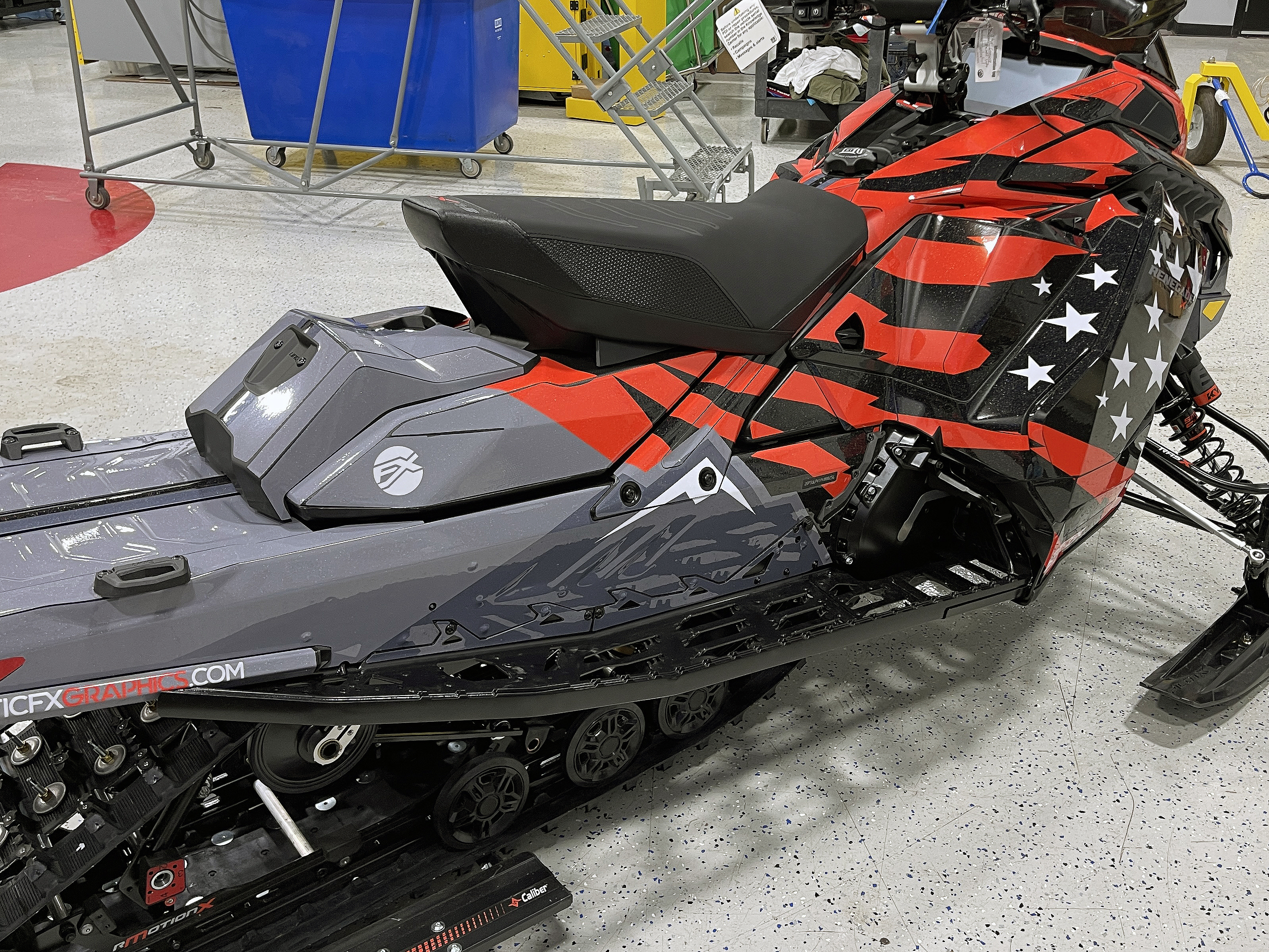 A Ski-Doo Gen5 Trail snowmobile with a red, white, and black Leif Alvarsson Merica custom vinyl wrap.