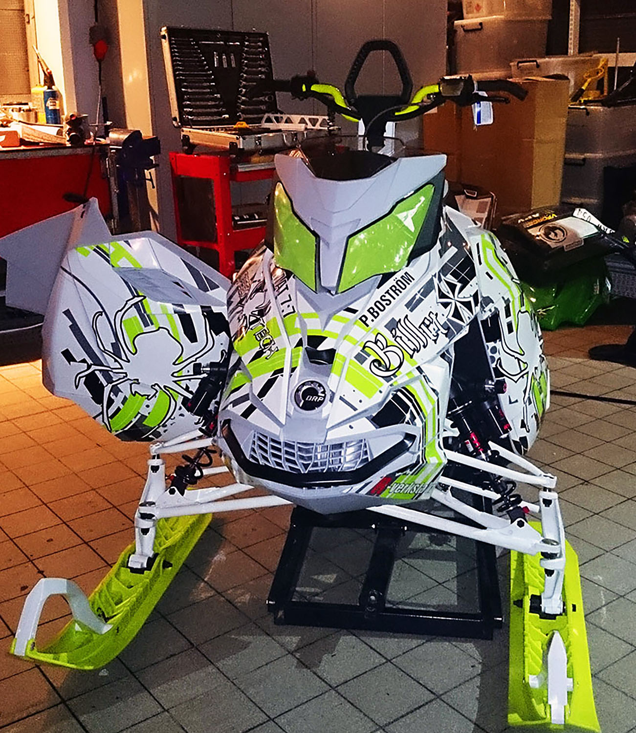 A Ski-Doo Rev XM snowmobile with a manta, white, black Arc Reactor custom vinyl wrap.