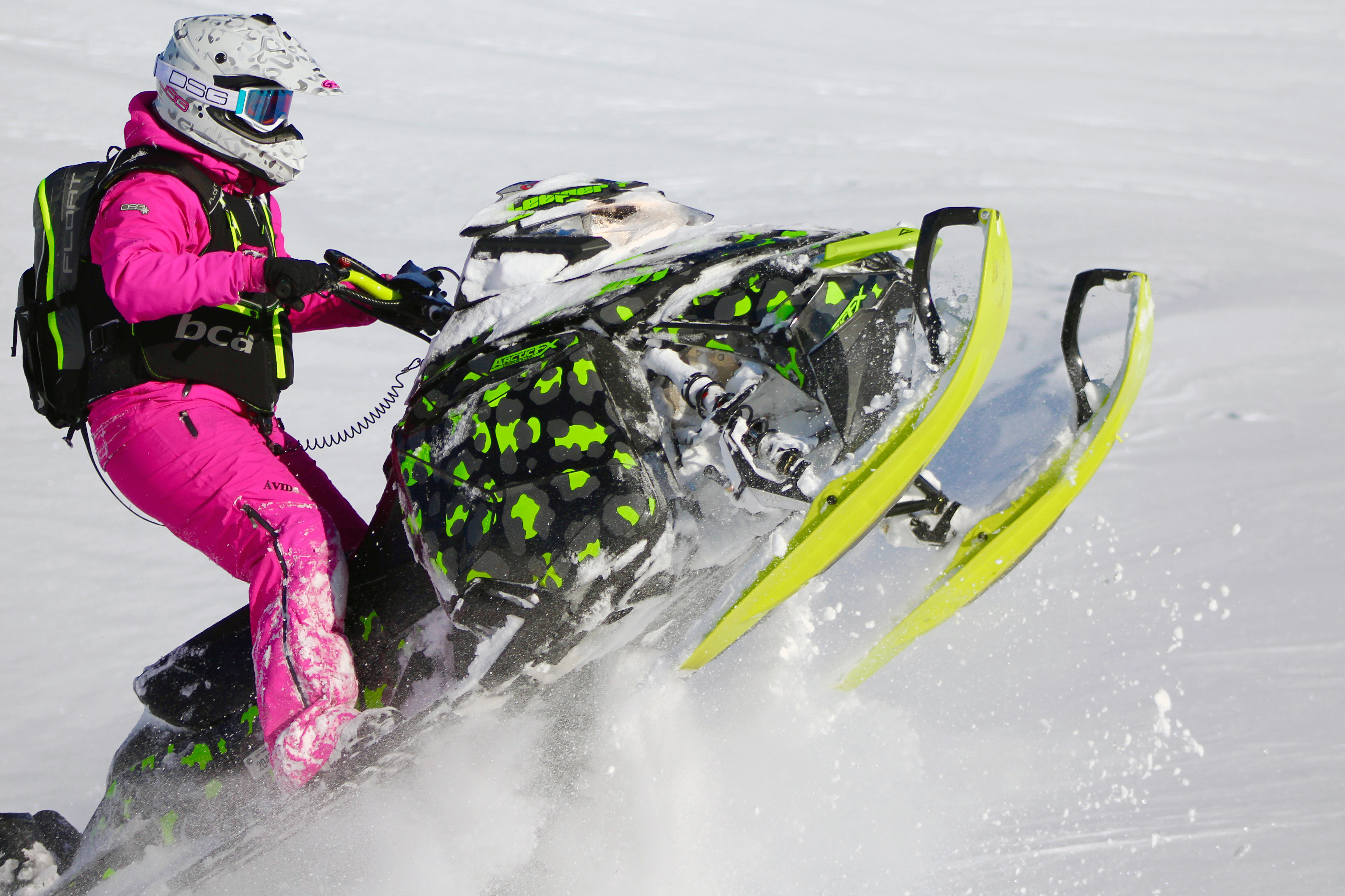 A Ski-Doo Rev XM snowmobile with a manta, gray, and black Cheetah Camo custom vinyl wrap.