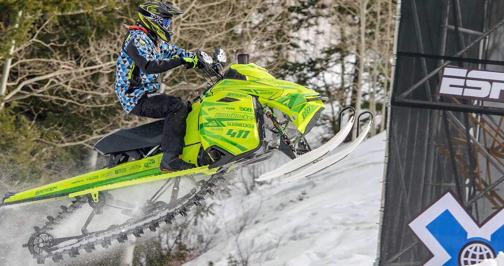 A Ski-Doo Rev XM snowmobile with a manta green Mentaberry custom vinyl wrap.