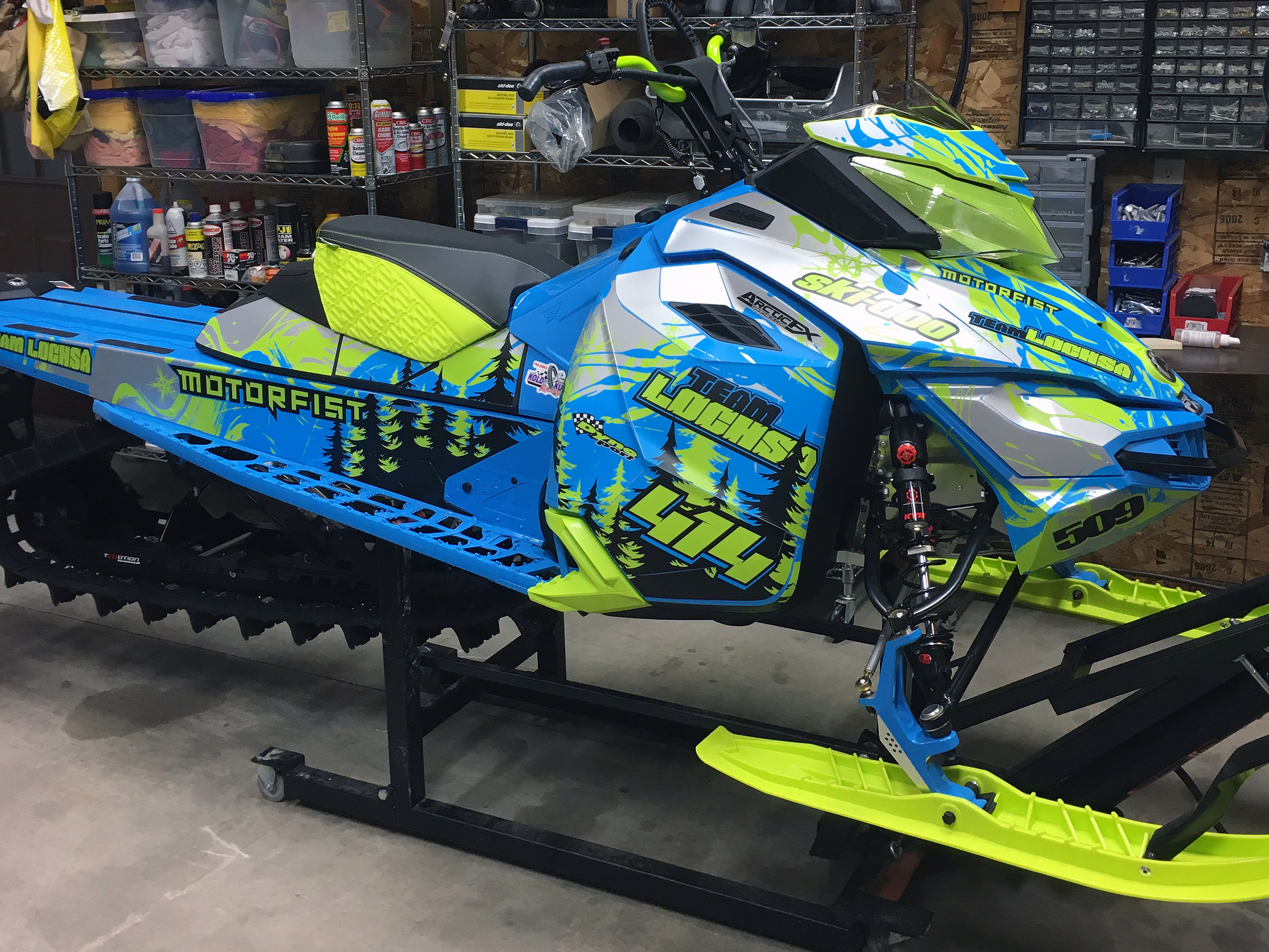 A Ski-Doo Rev XM snowmobile with a manta, octane blue, and gray Sub Zero custom vinyl wrap.