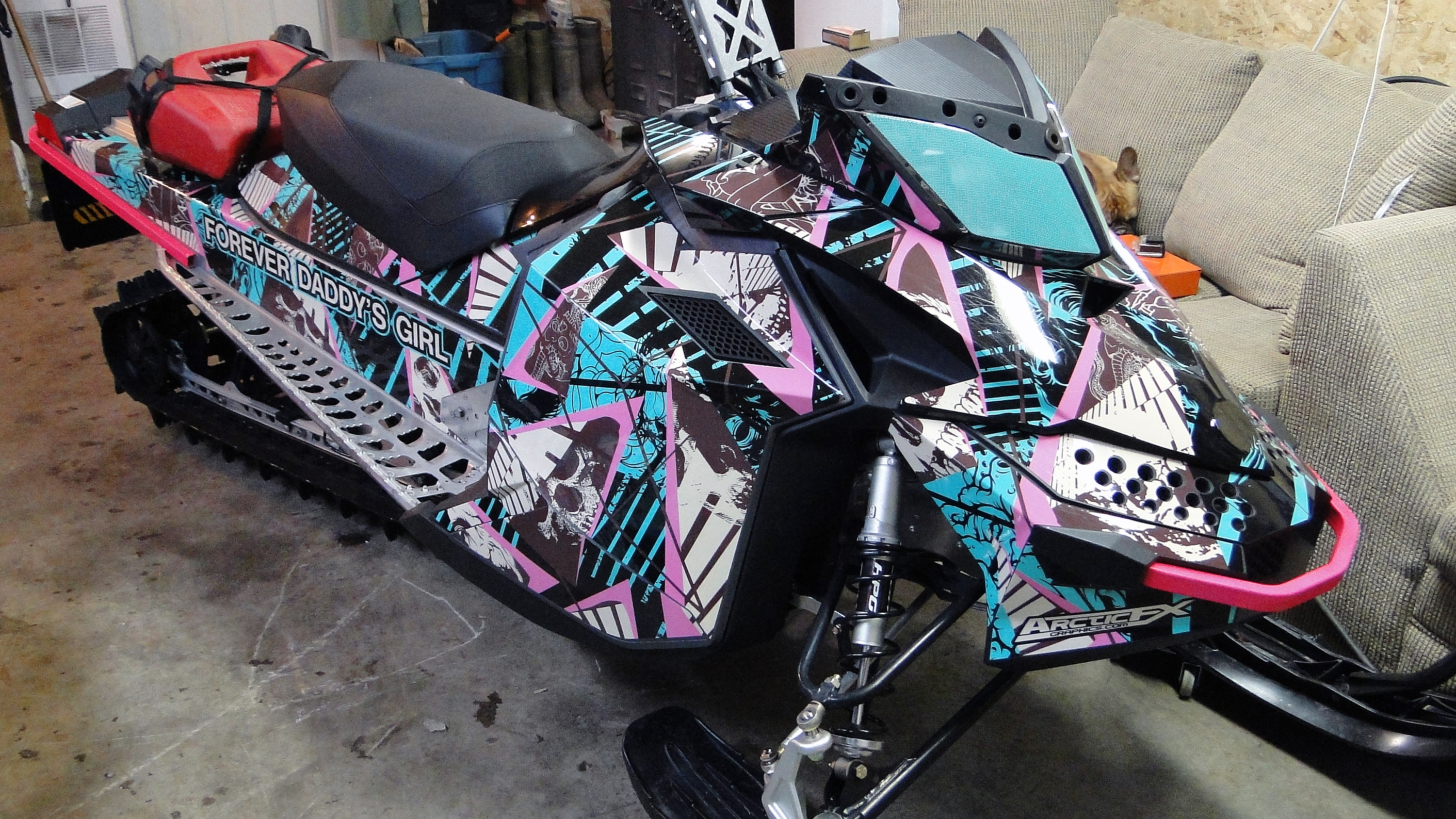 A Ski-Doo Rev XP snowmobile with a pink, blue, and white Broken Arrow custom vinyl wrap.