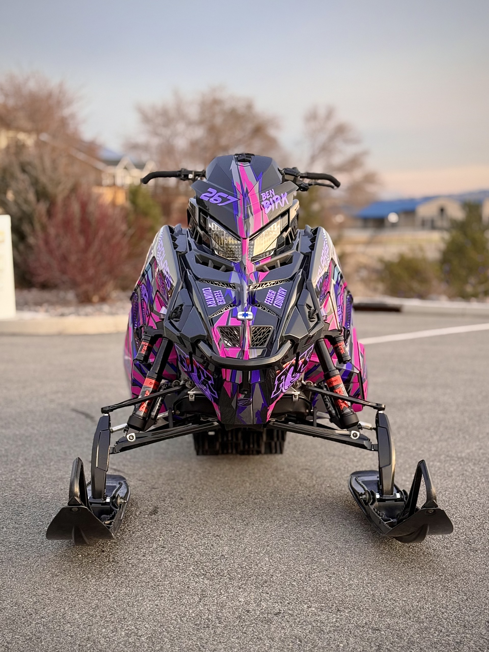 A Polaris Matryx Mountain snowmobile with a lilac purple, gunmetal gray, ink blue, stealth gray, hot pink, and violet purple Initialize custom vinyl wrap.