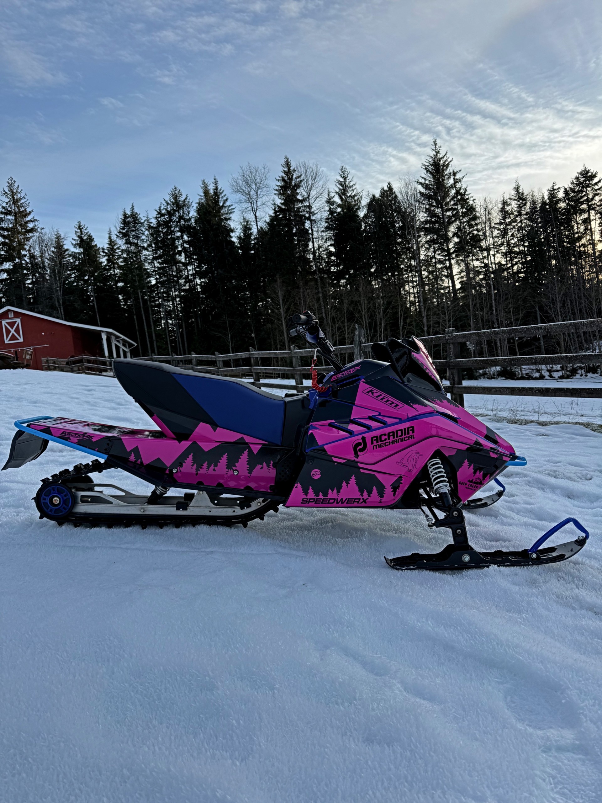 A Yamaha Snoscoot snowmobile with a black, and hot pink KLIM Legacy custom vinyl wrap.