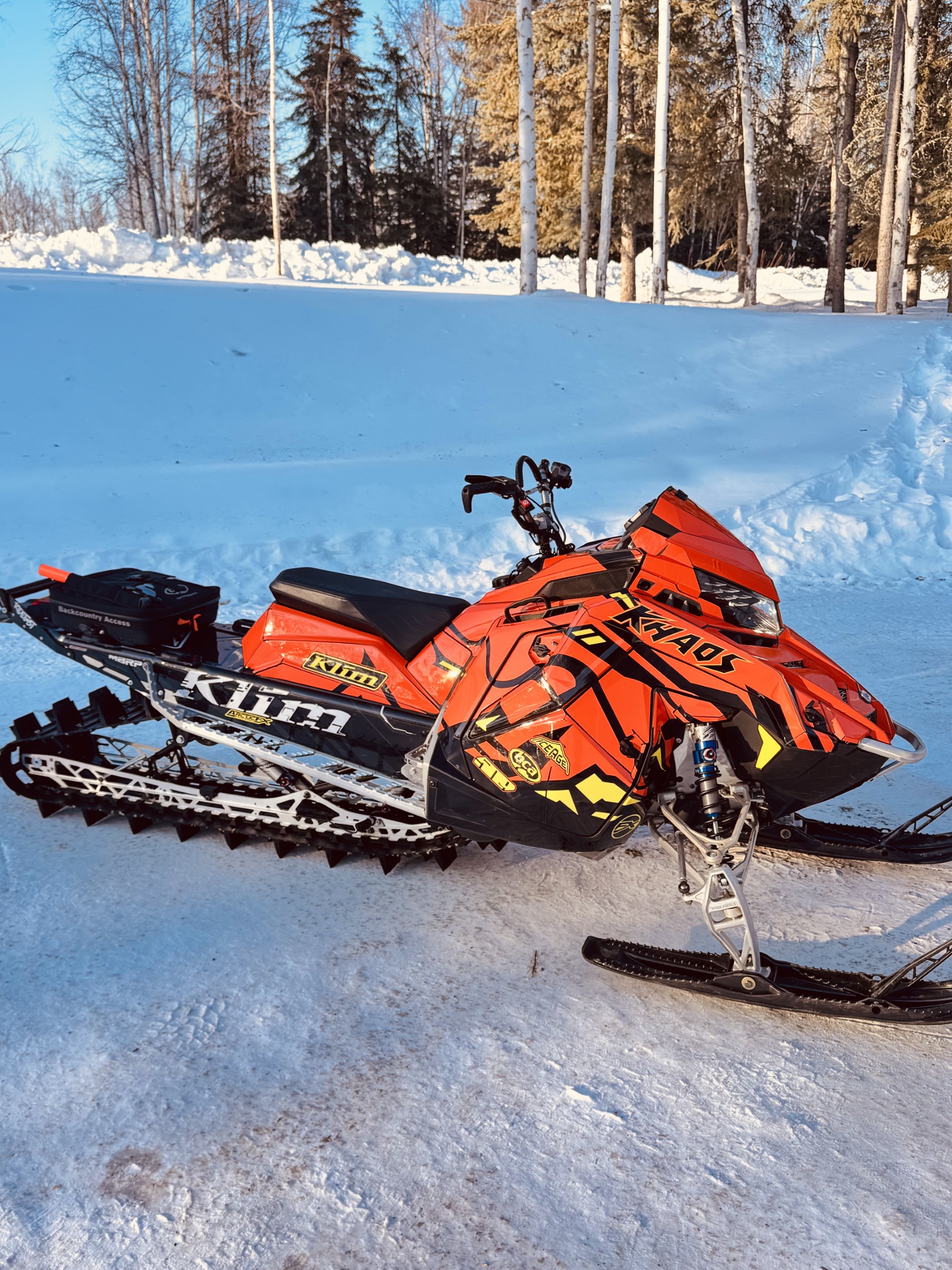 A Polaris Matryx Mountain snowmobile with a white, black, axys burst, lime squeeze Leif Alvarsson Grounding custom vinyl wrap.
