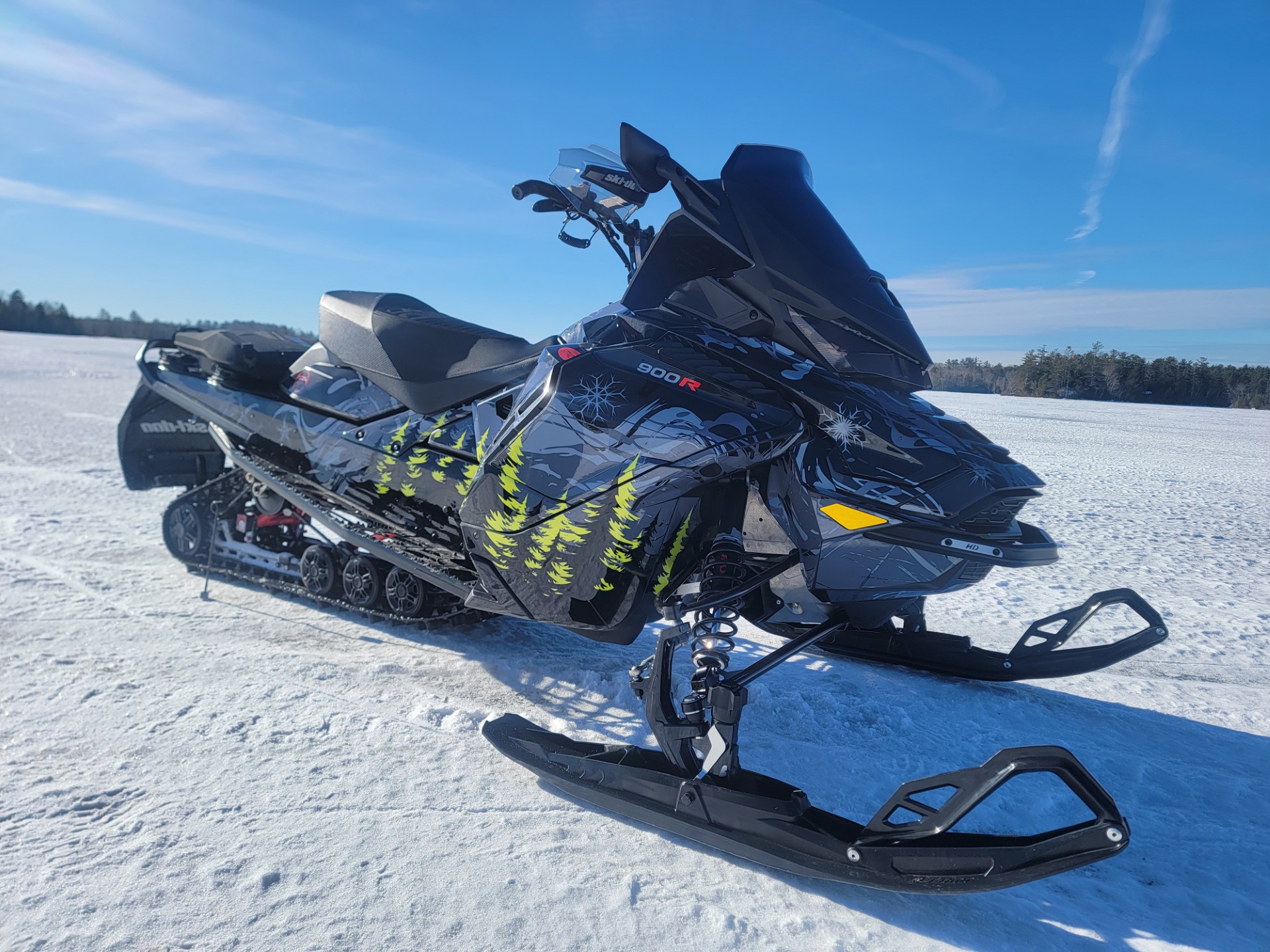 A SkiDoo Gen4 Wide Body snowmobile with a black, monument gray, stealth gray, and manta green Sub Zero custom vinyl wrap.