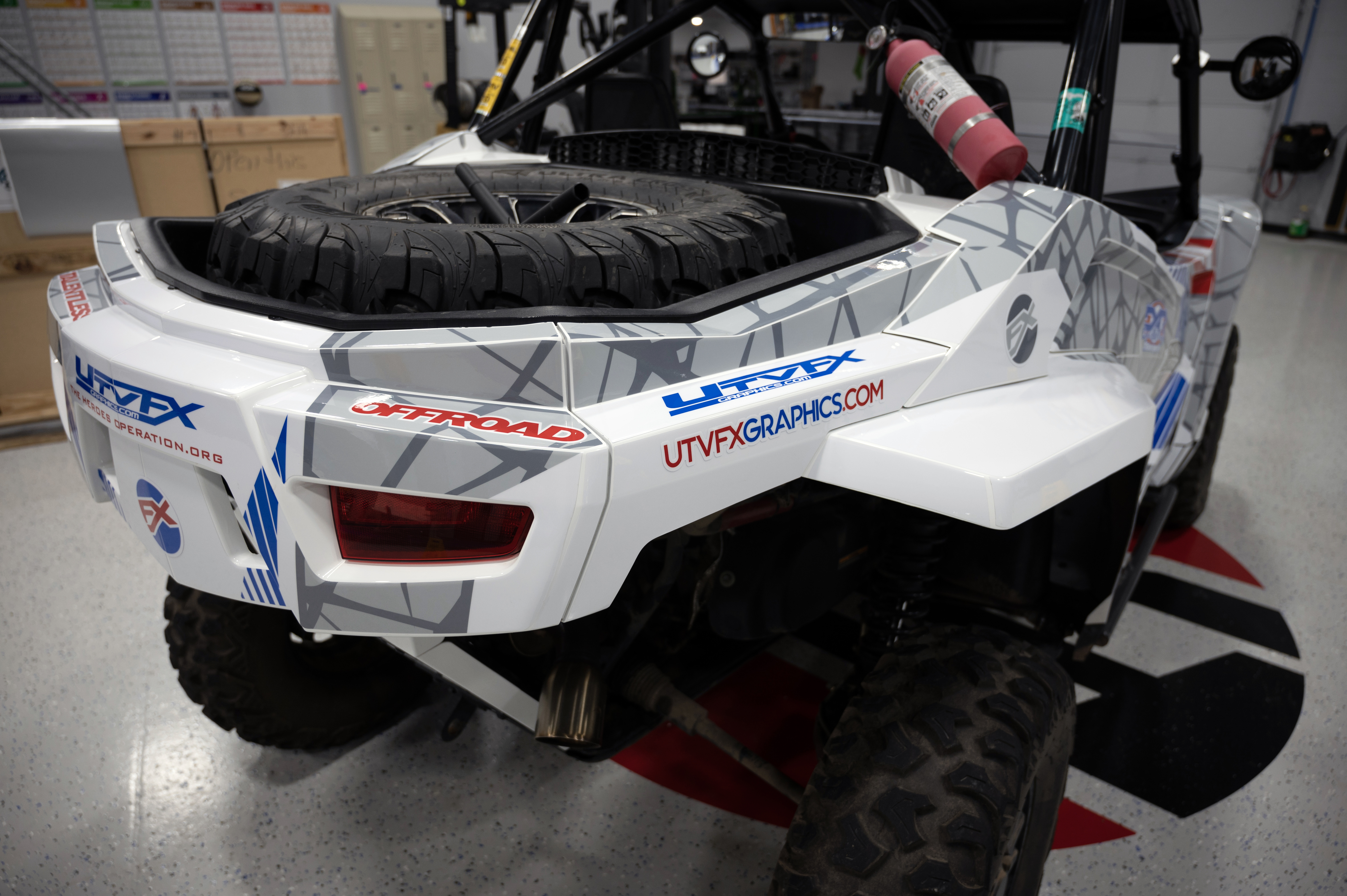 A Arctic Cat Wildcat XX side-by-side with a red, white, and blue American hero Fractal custom vinyl wrap.