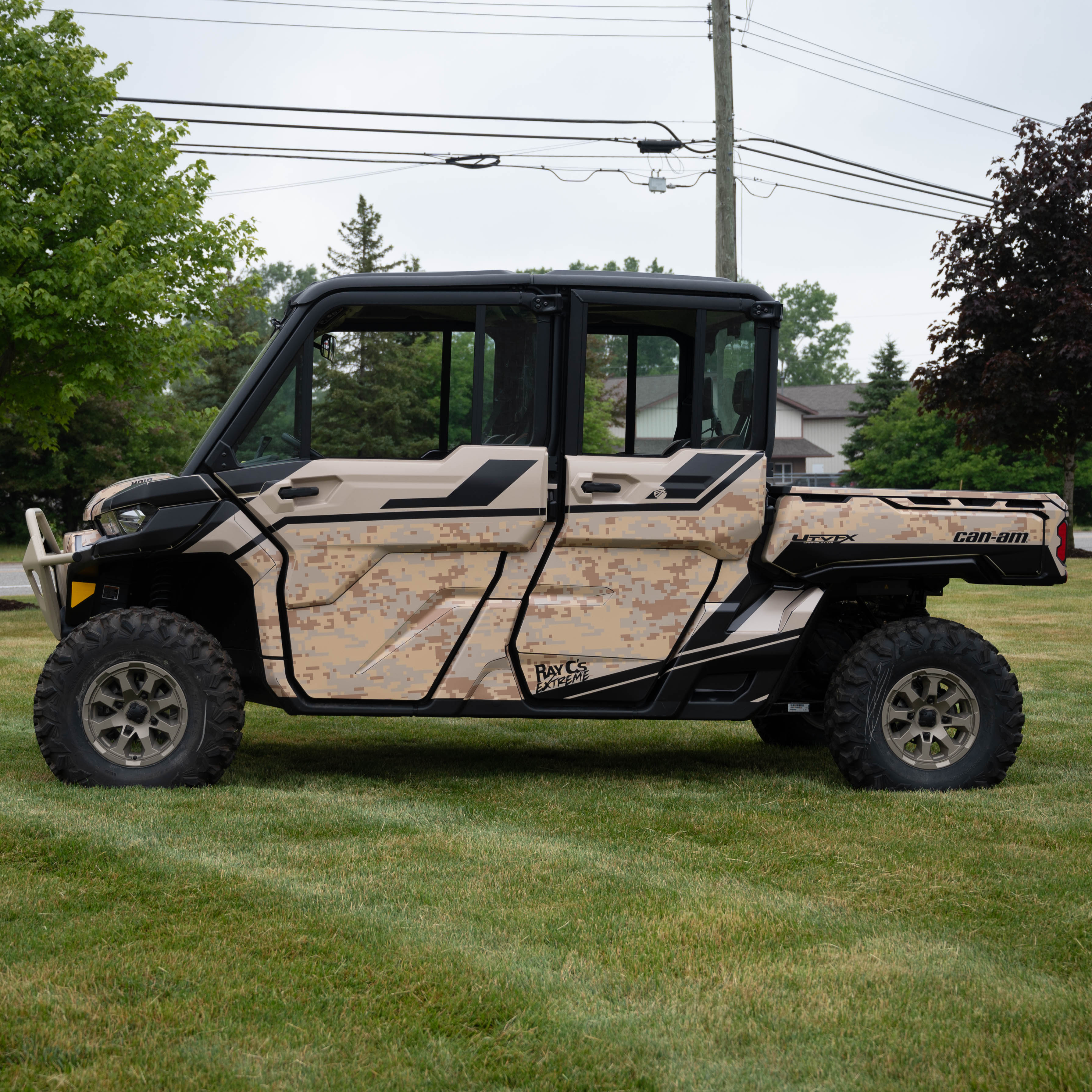 A Can-am Defender Max with a tan and black digital camo custom wrap